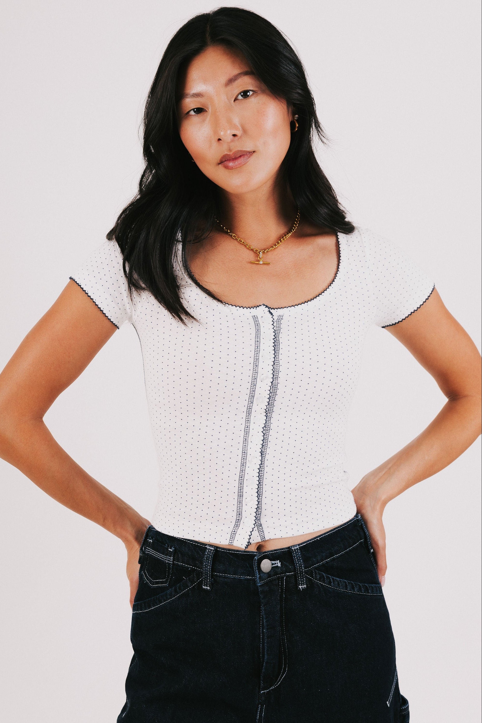 white top with navy polka dots and seams
