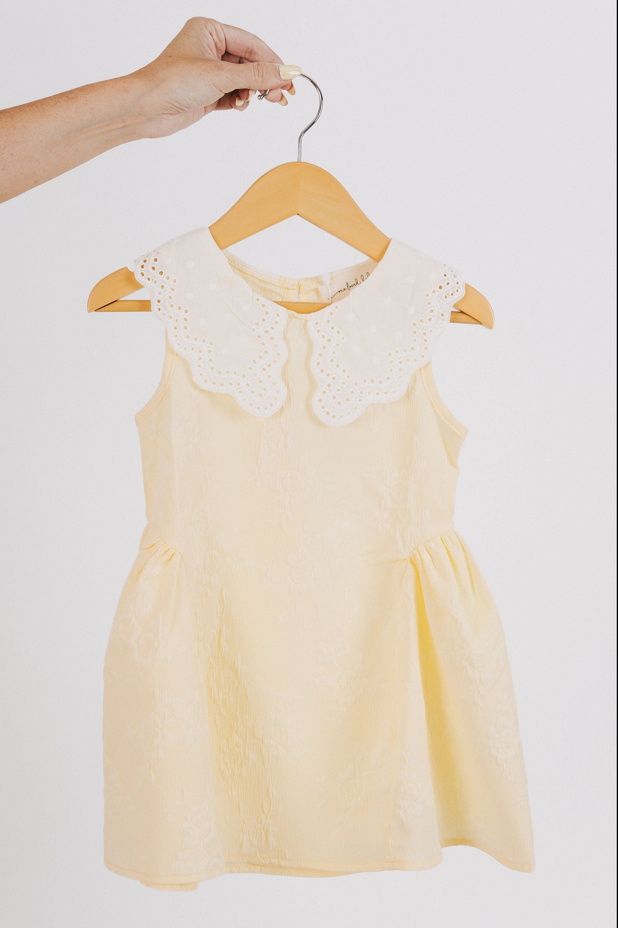 yellow baby dress with white eyelet collar