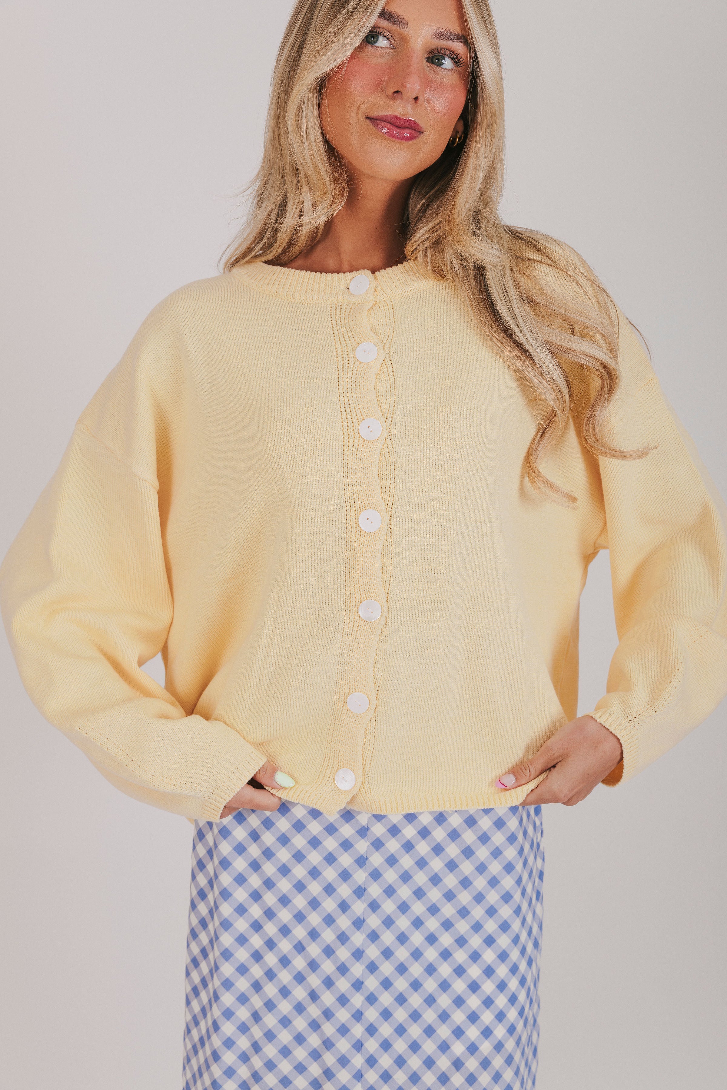 Light yellow sweater with a button down front and long sleeves