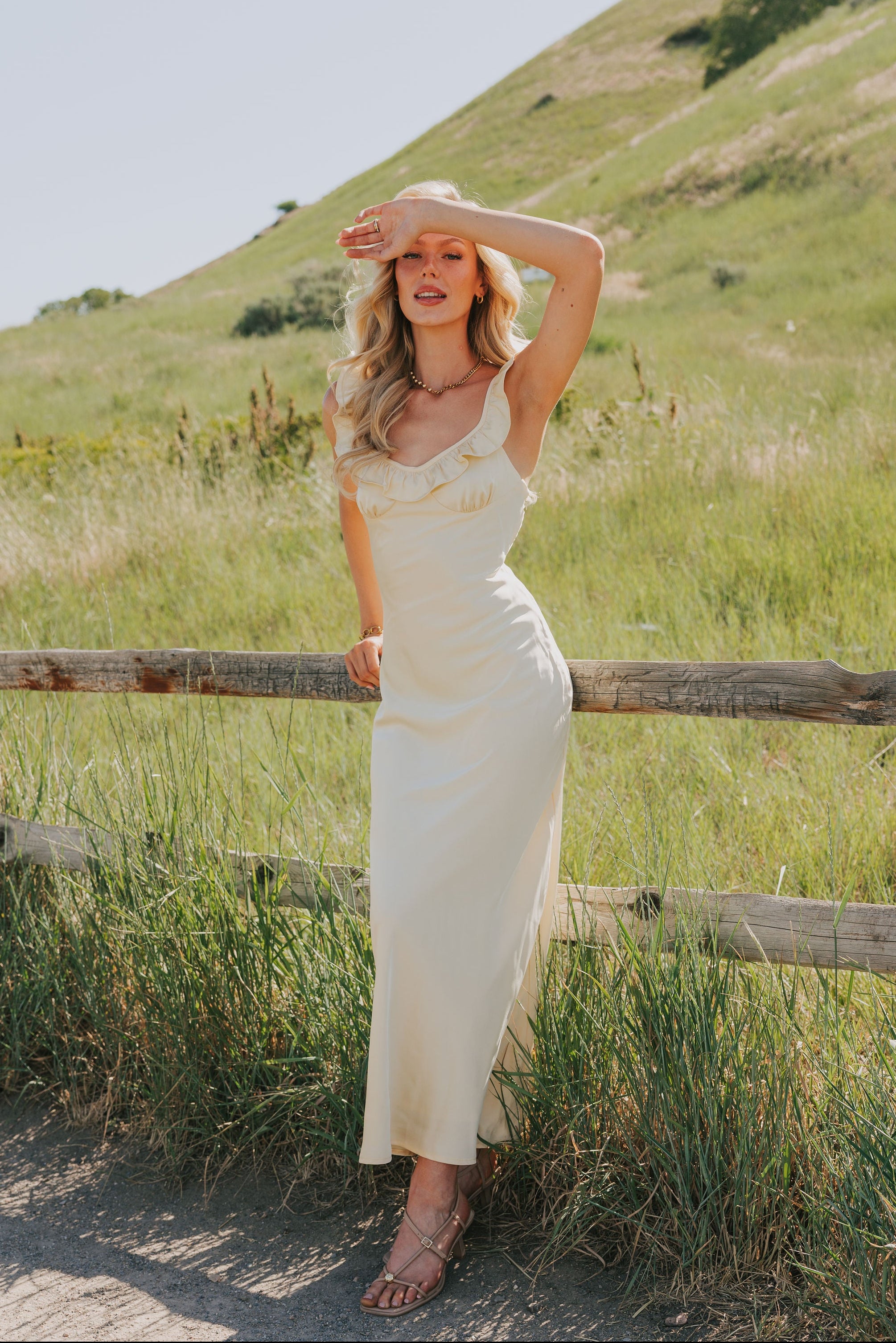 yellow satin dress with ruffle trim on neckline lifestyle