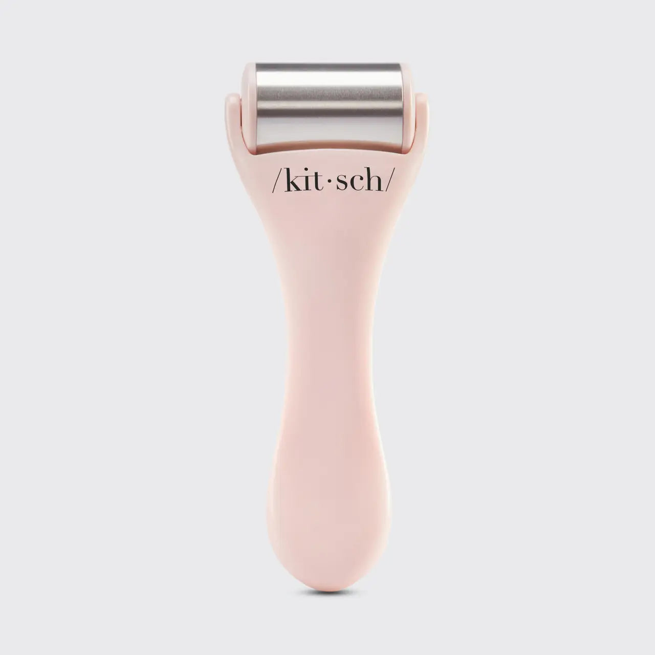 A pink ice roller with a handle and metal roller, branded with '/kitsch/', against a white background.