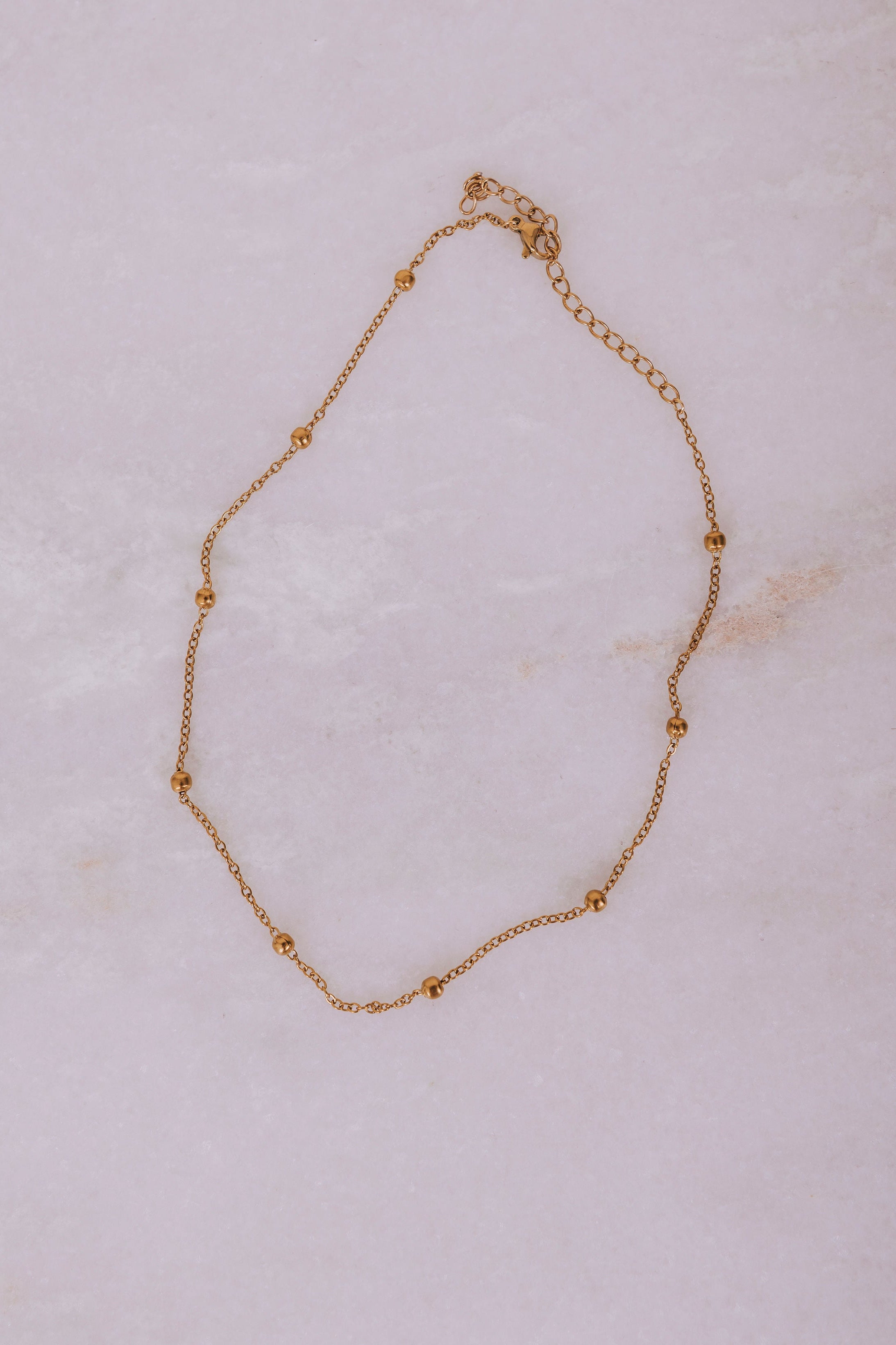 14k gold bead necklace flatlay