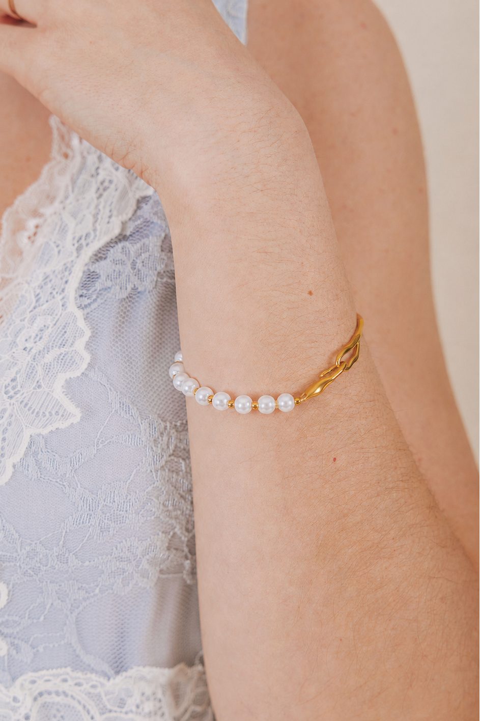 Asymmetrical bracelet with half gold and half pearl with gold bead accents 