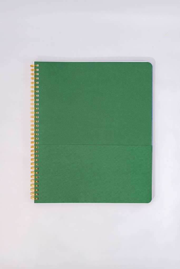 notebook with gold spiral binding on a white background green center fold page 