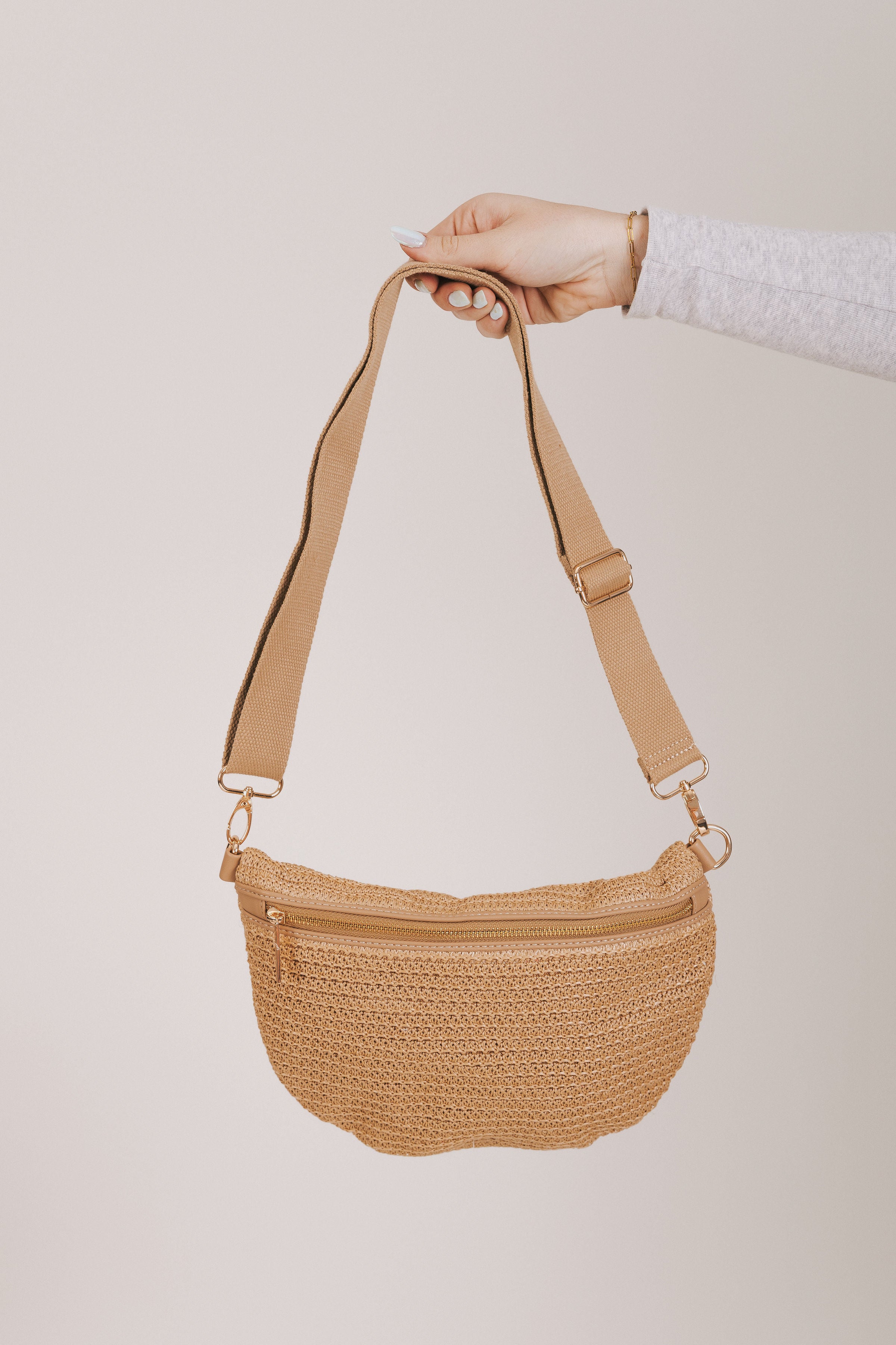 beige woven bag with adjustable strap