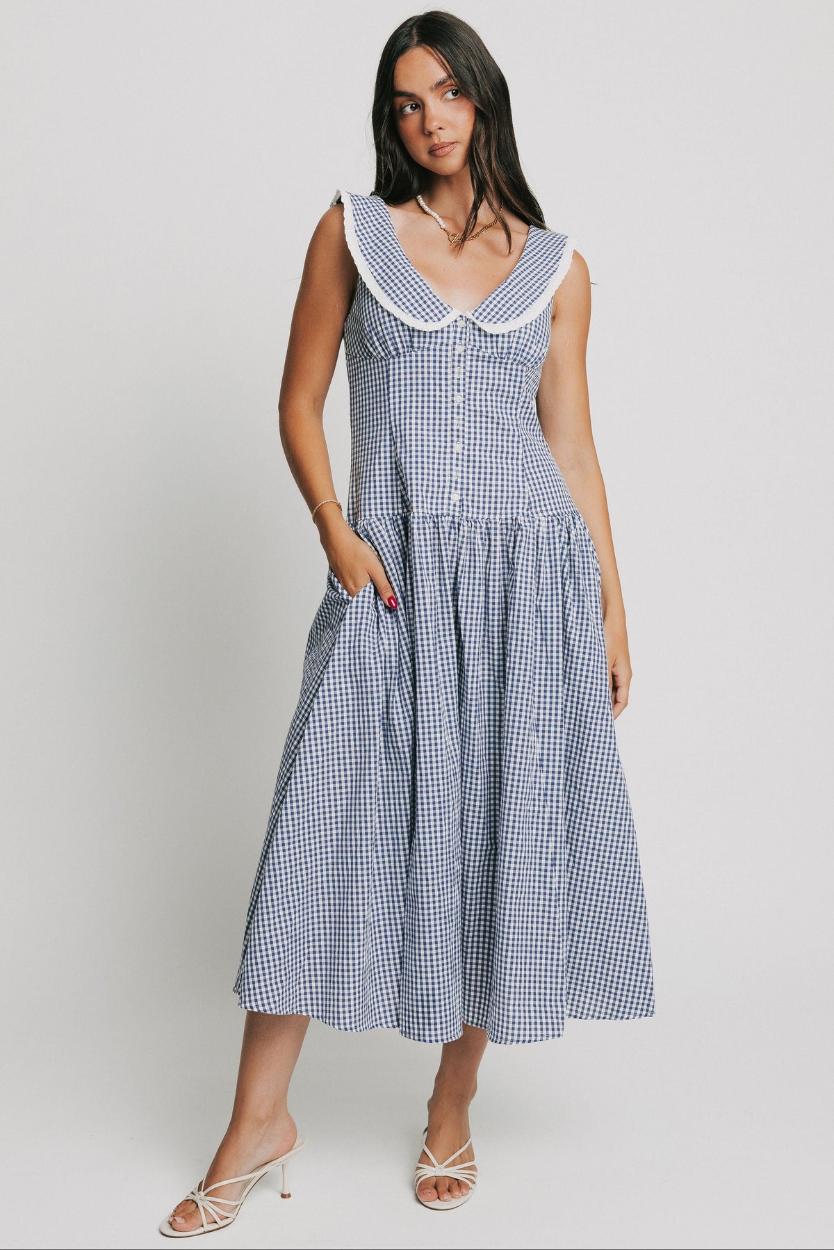 blue and white sleeveless gingham dress with drop waist and collar