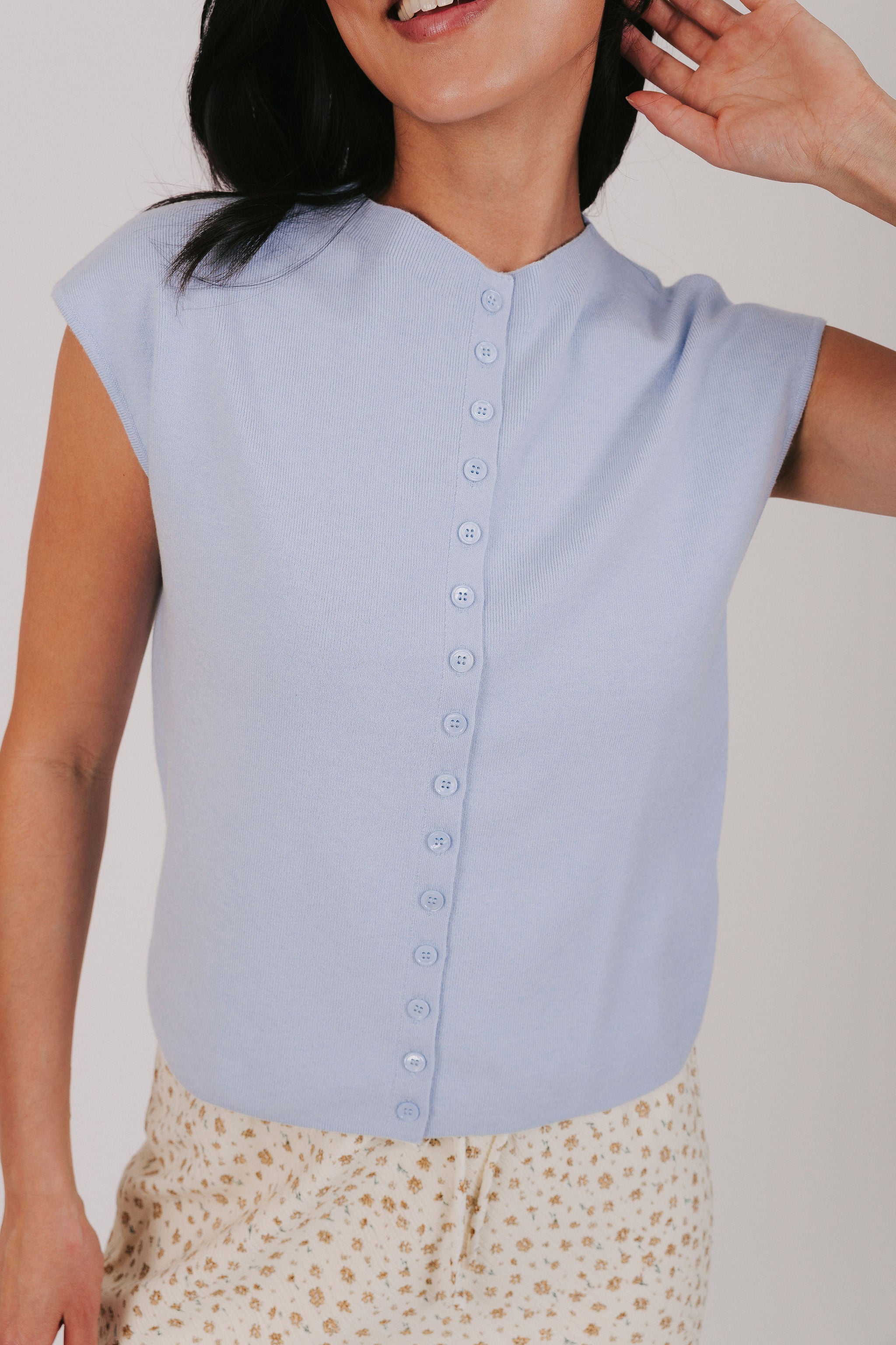 blue top with cap sleeves and buttons down the front
