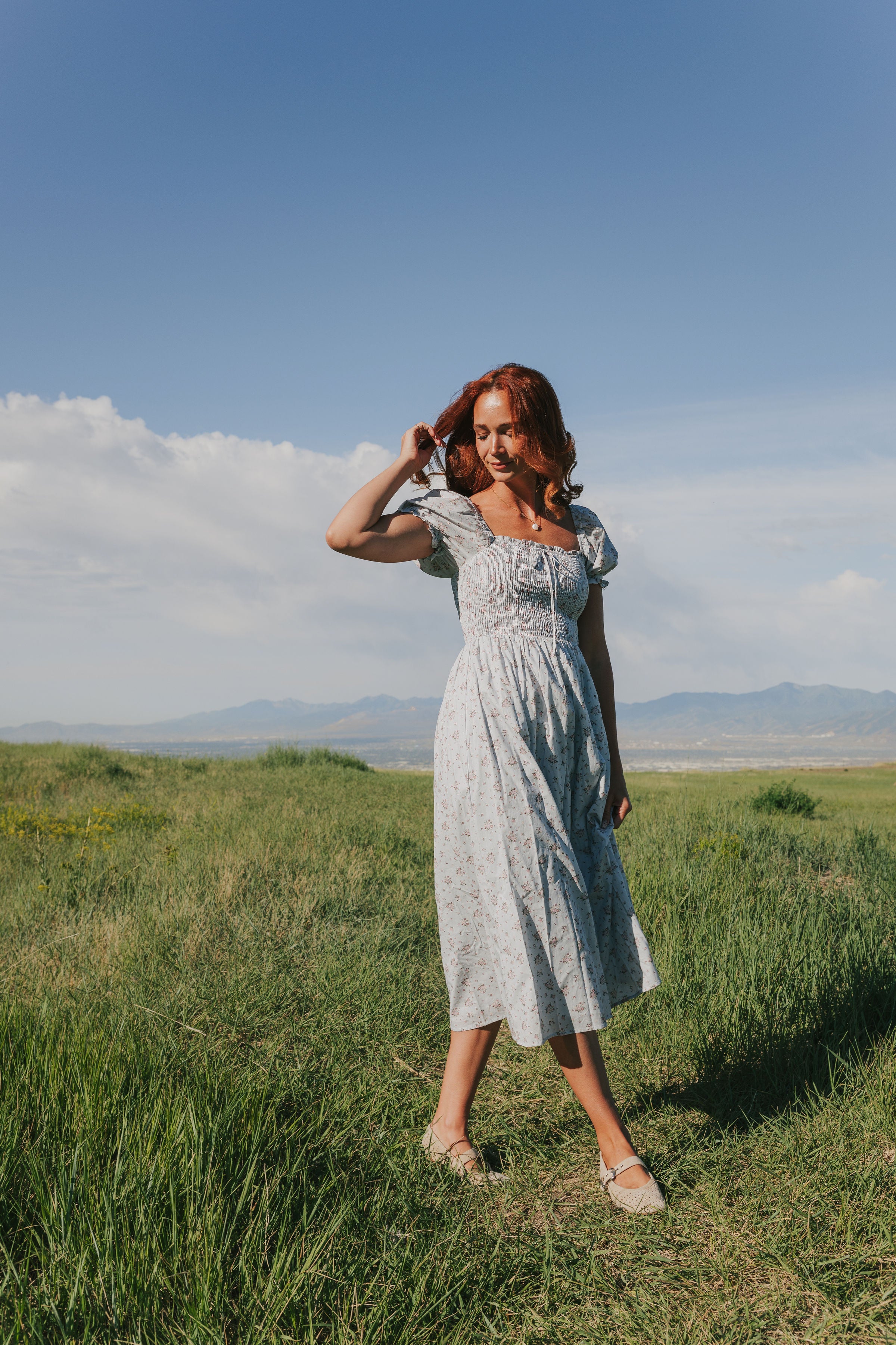 Light blue dress with puff sleeves midi length shirred bodice 