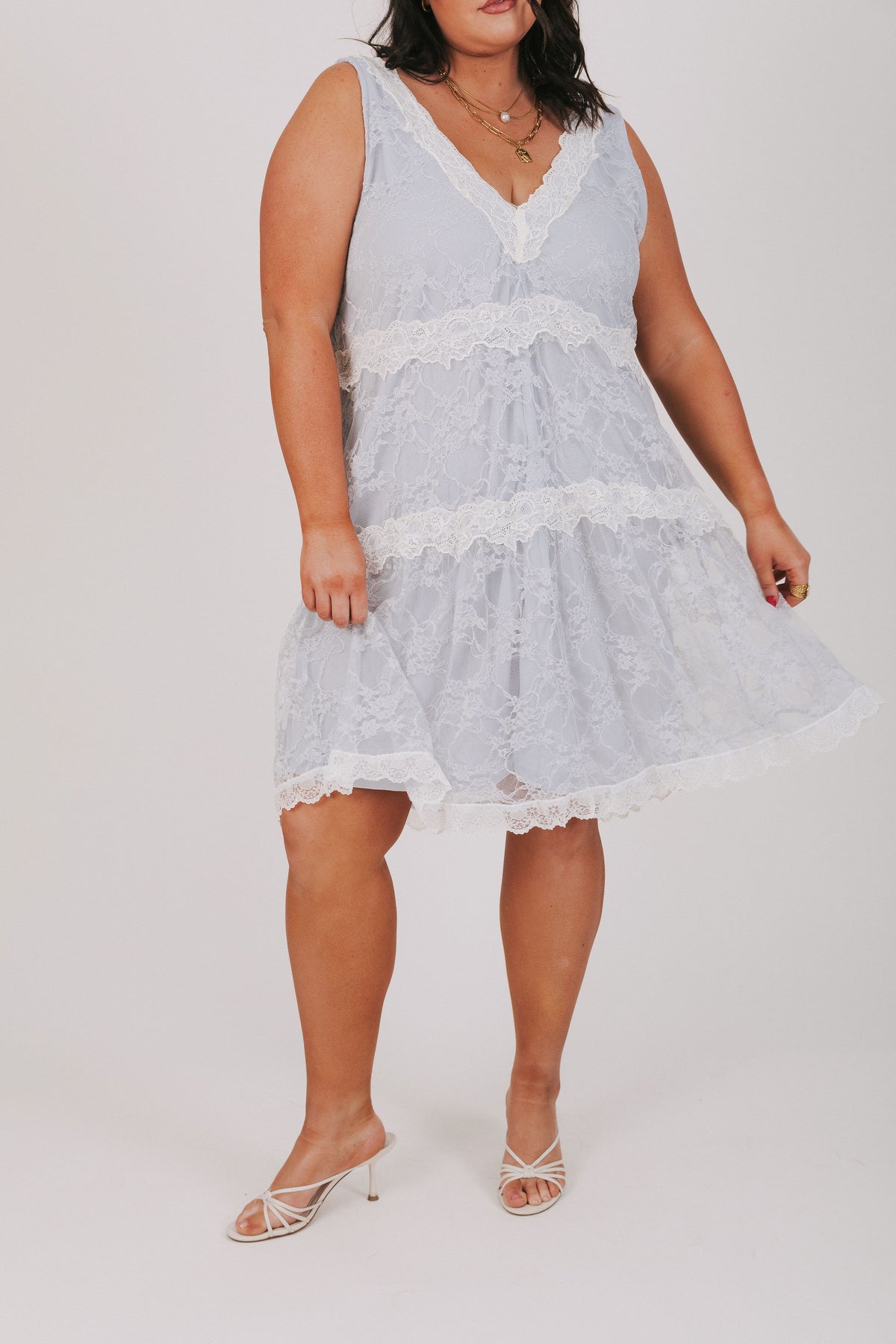 Blue dress with lace overlay and contrast lace trim. V-neckline, sleeveless and knee length