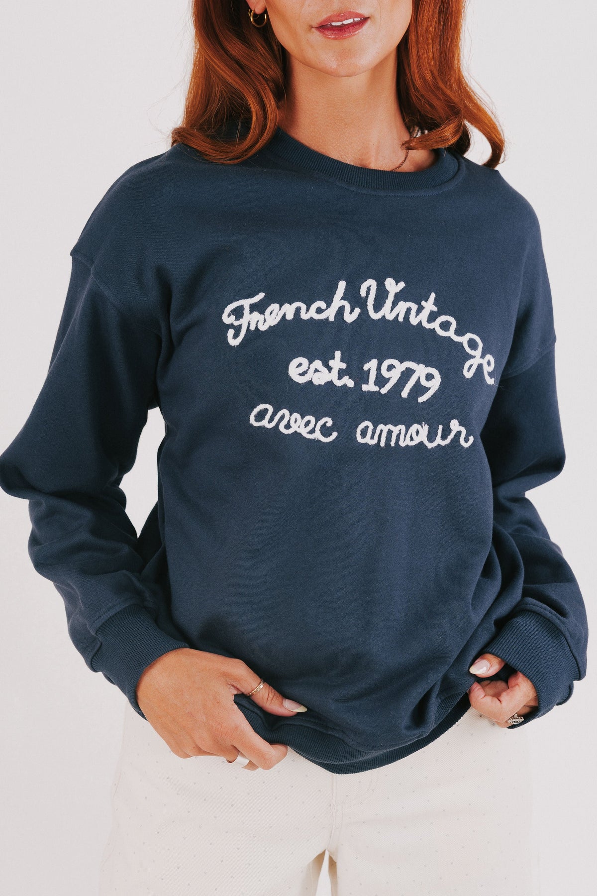 blue sweatshirt with white embroidered words front