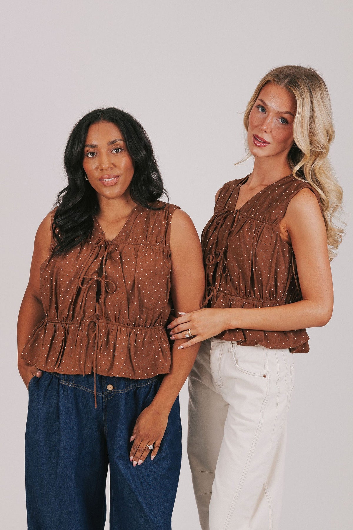 Brown top/vest with white polka dots. sleeveless open front tied bows ruching and gathered 