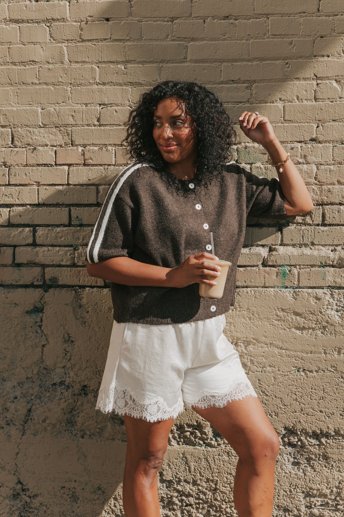 brown short sleeve cardigan with stripes on shoulders lifestyle