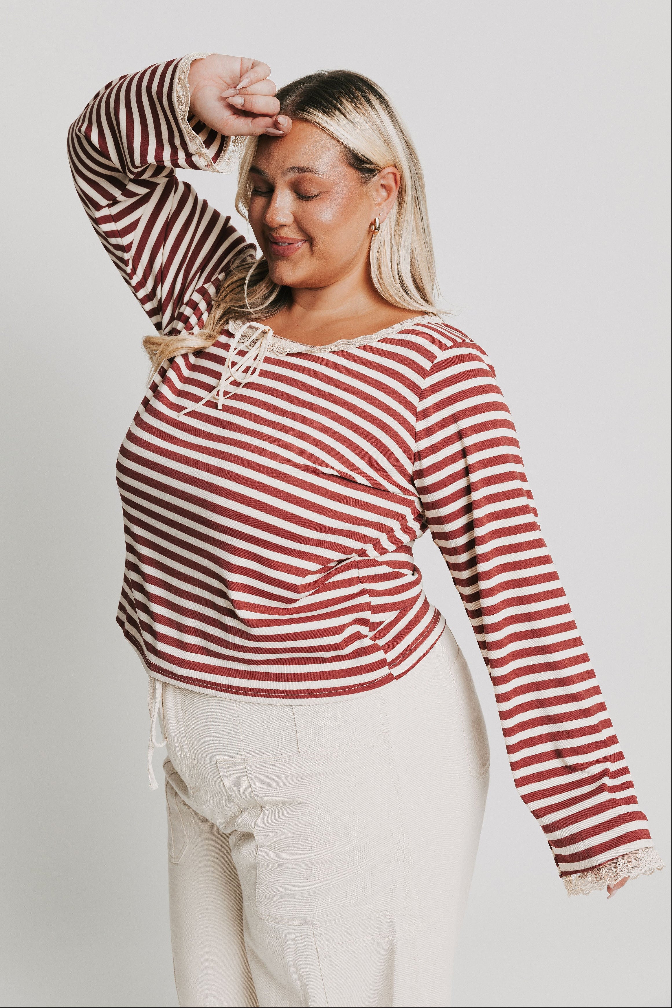 burgundy striped top with lace trim on neckline and sleeves