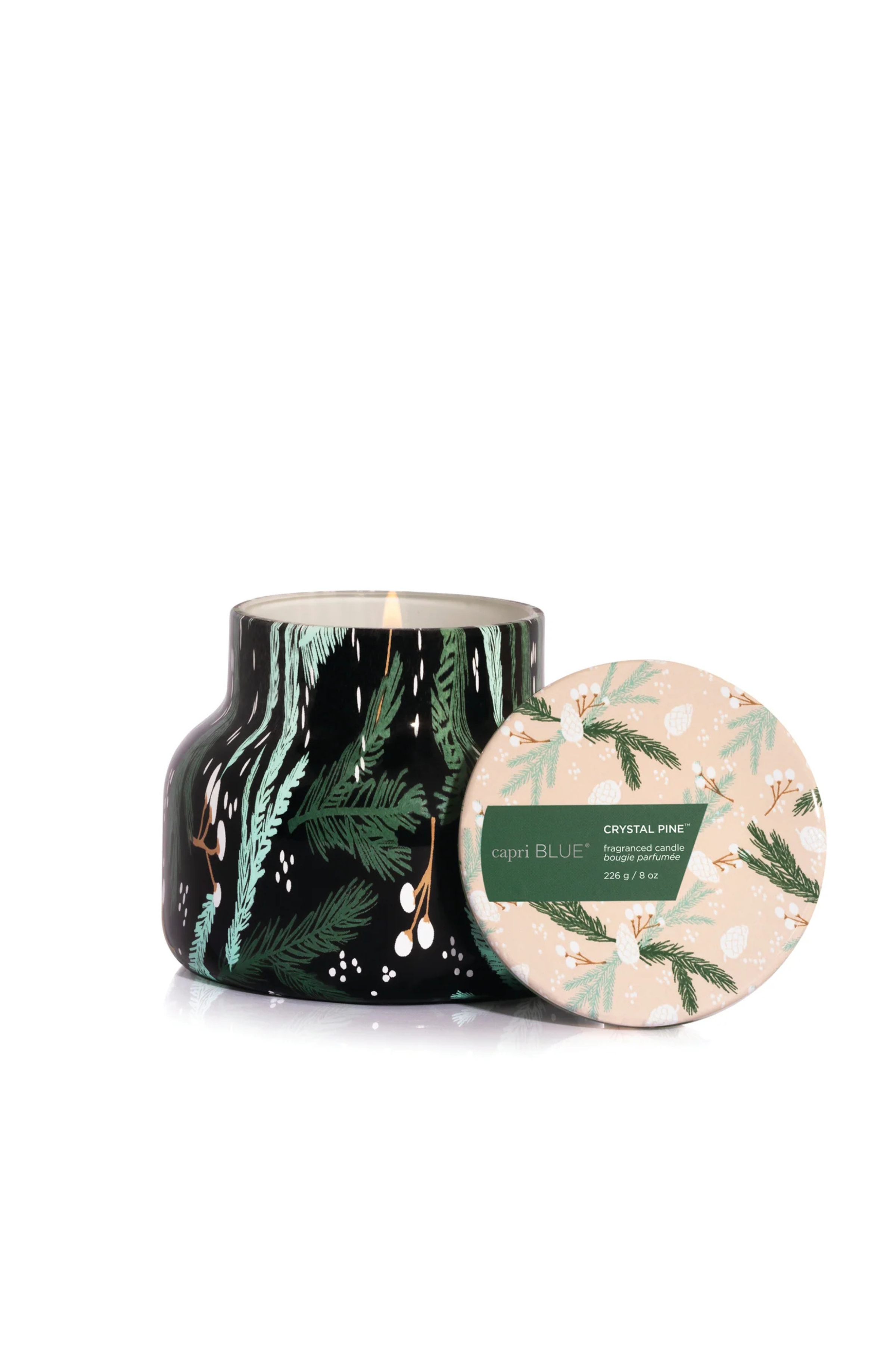 Tree sprig patterned candle in scent crystal pine by capri blue.