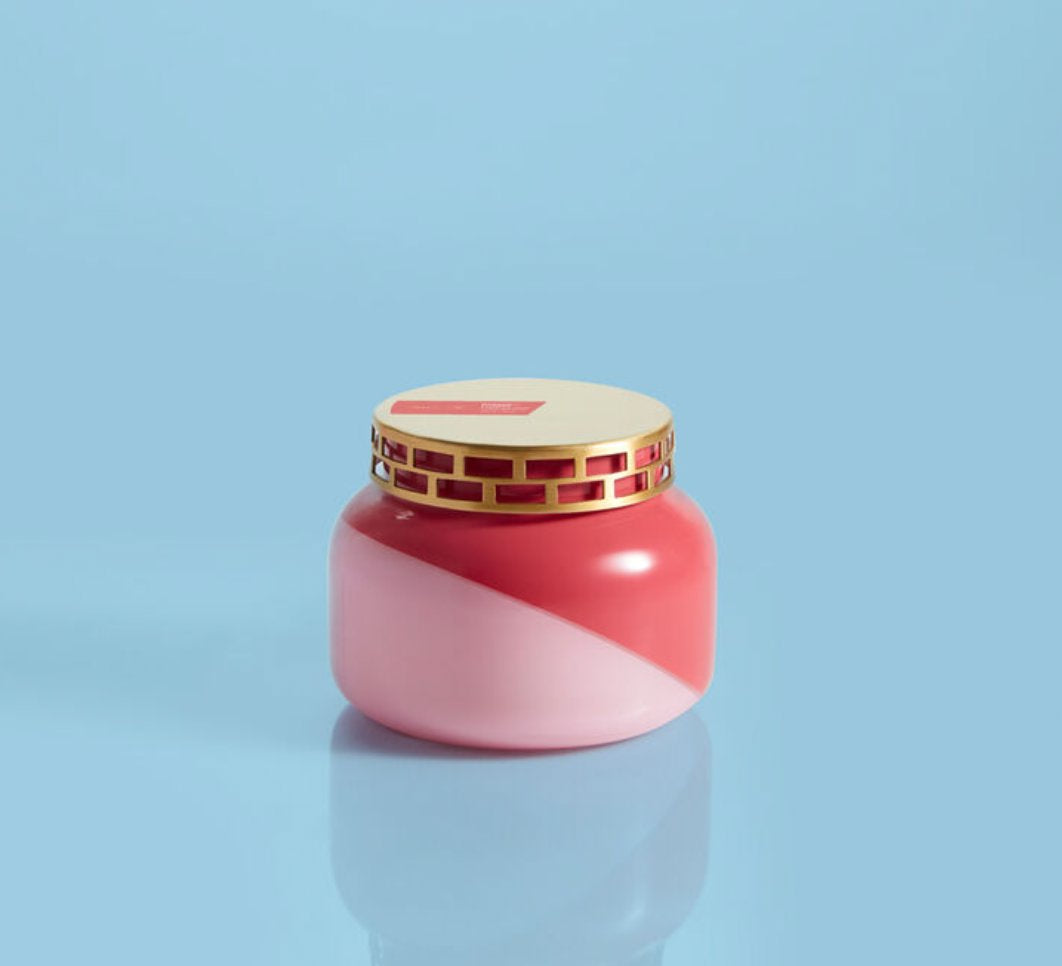 Pink and fuchsia colored candle with gold brushed lid. 