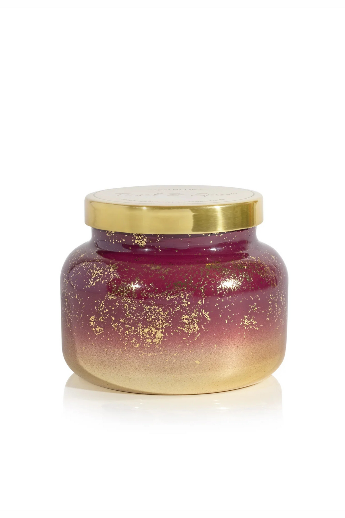 Red candle with gold gradient and gold flecks with a gold lid in tinsel and spice by capri blue.