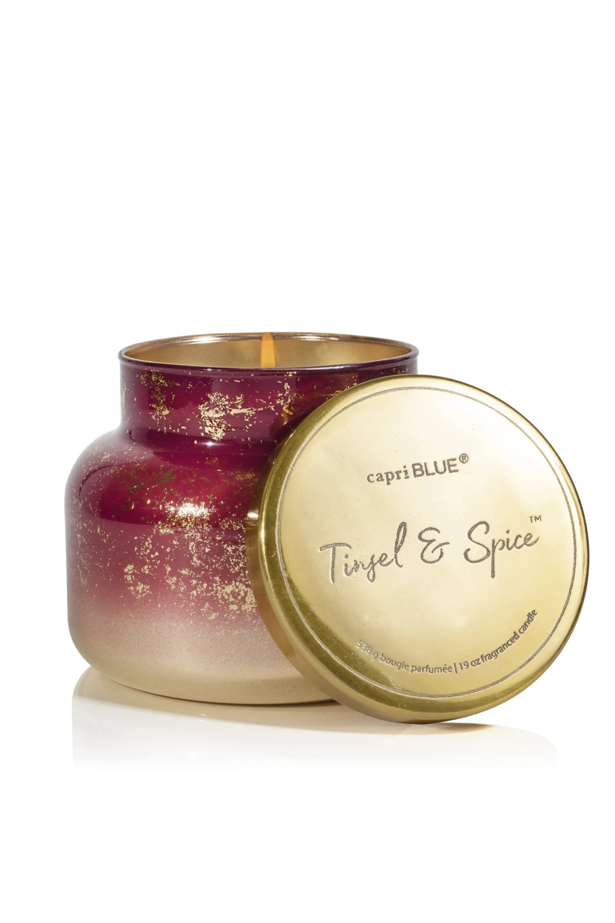 Red and gold gradient candle in tinsel and spice by capri blue.