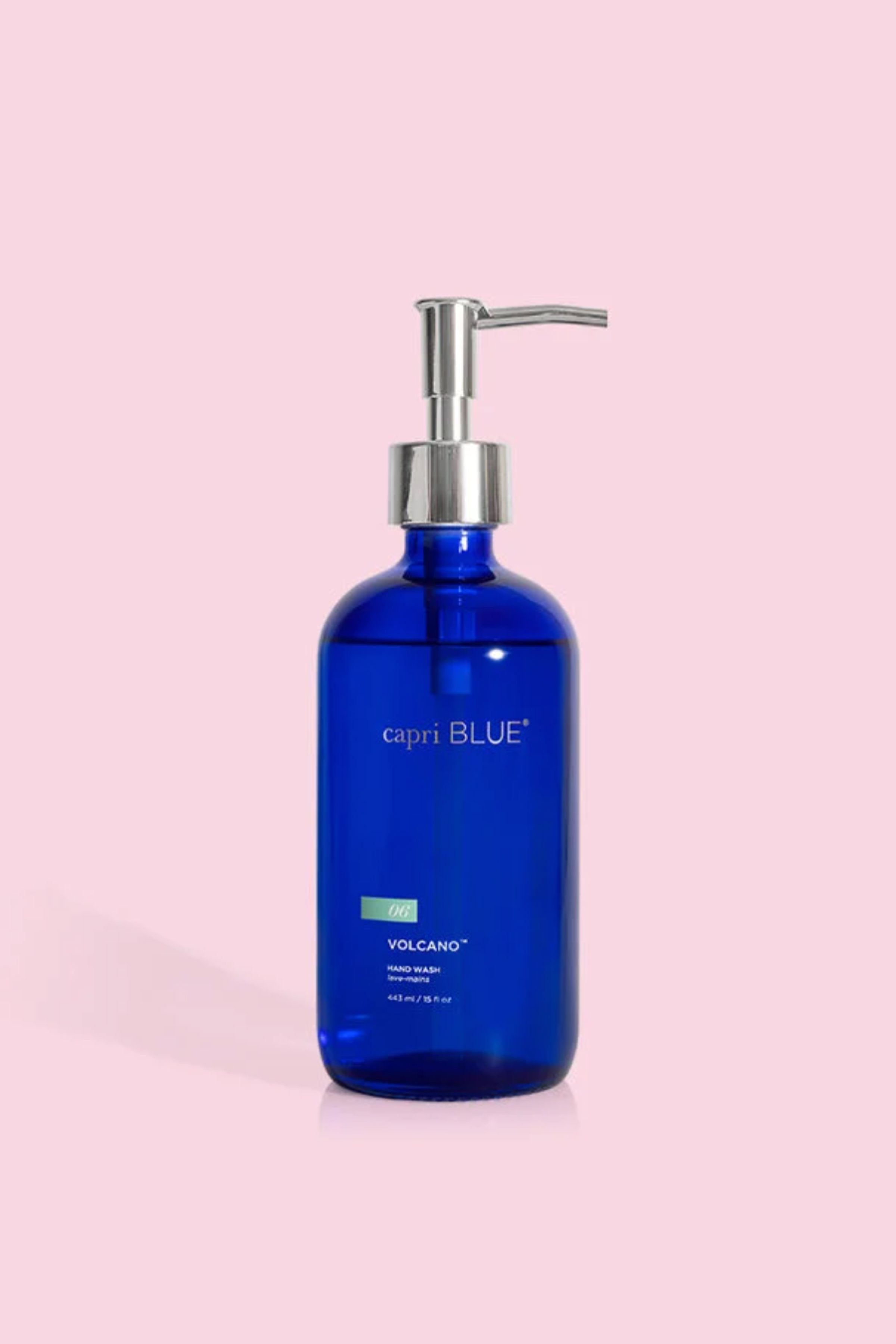 Blue bottle with pump on a pink background