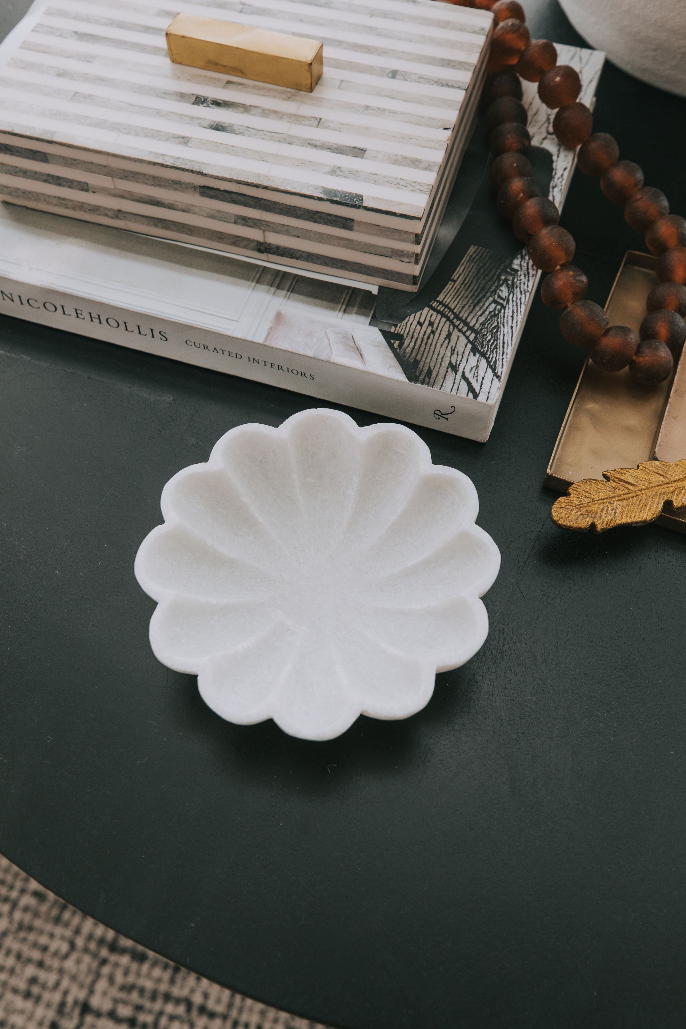 white marble dish carved dish shaped like a flower.