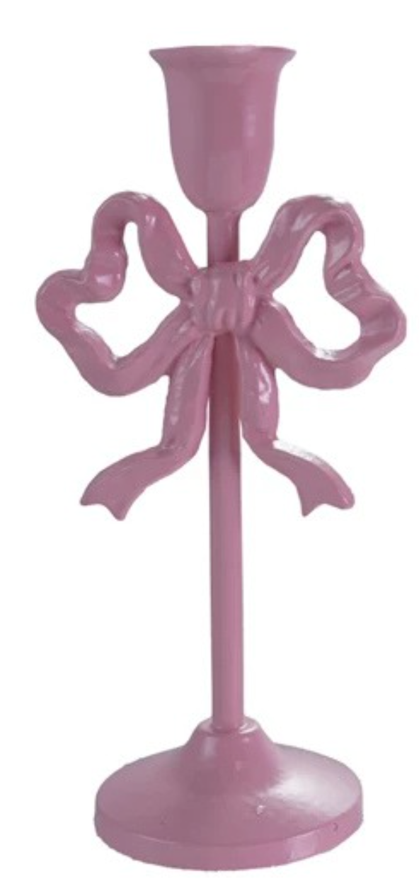 Pink candle holder with bow design on a white background