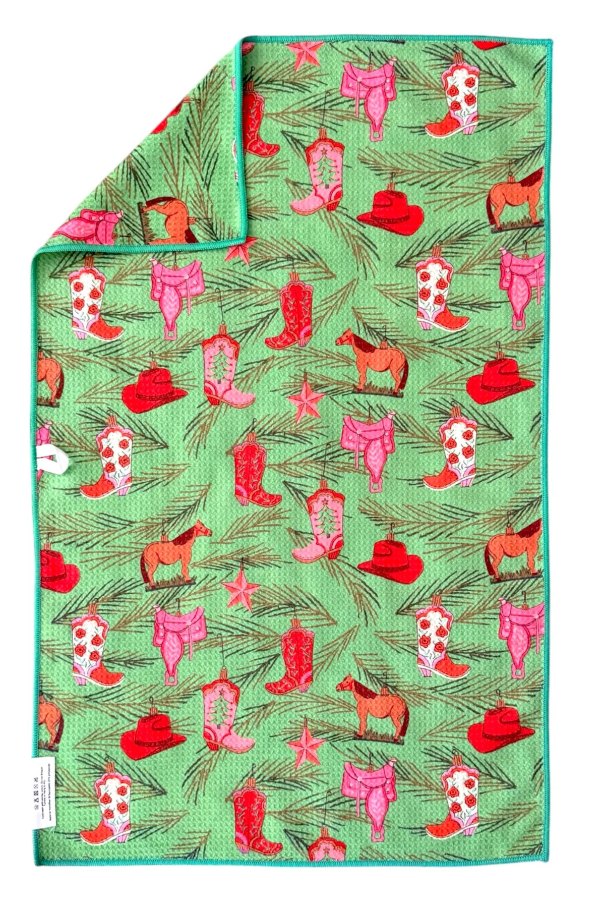 Green hand towel with cowboy boot, hat, and horse pattern