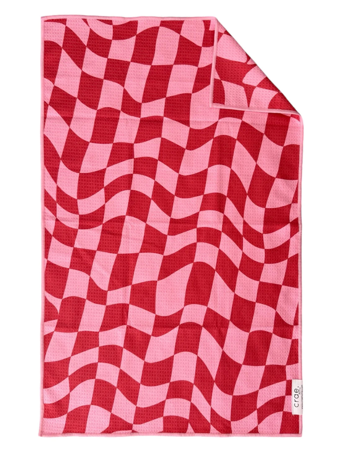 A double-sided microfiber hand towel with a red and pink geometric pattern