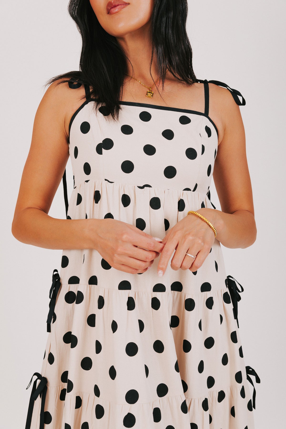 cream and black polka dot dress with bow details 