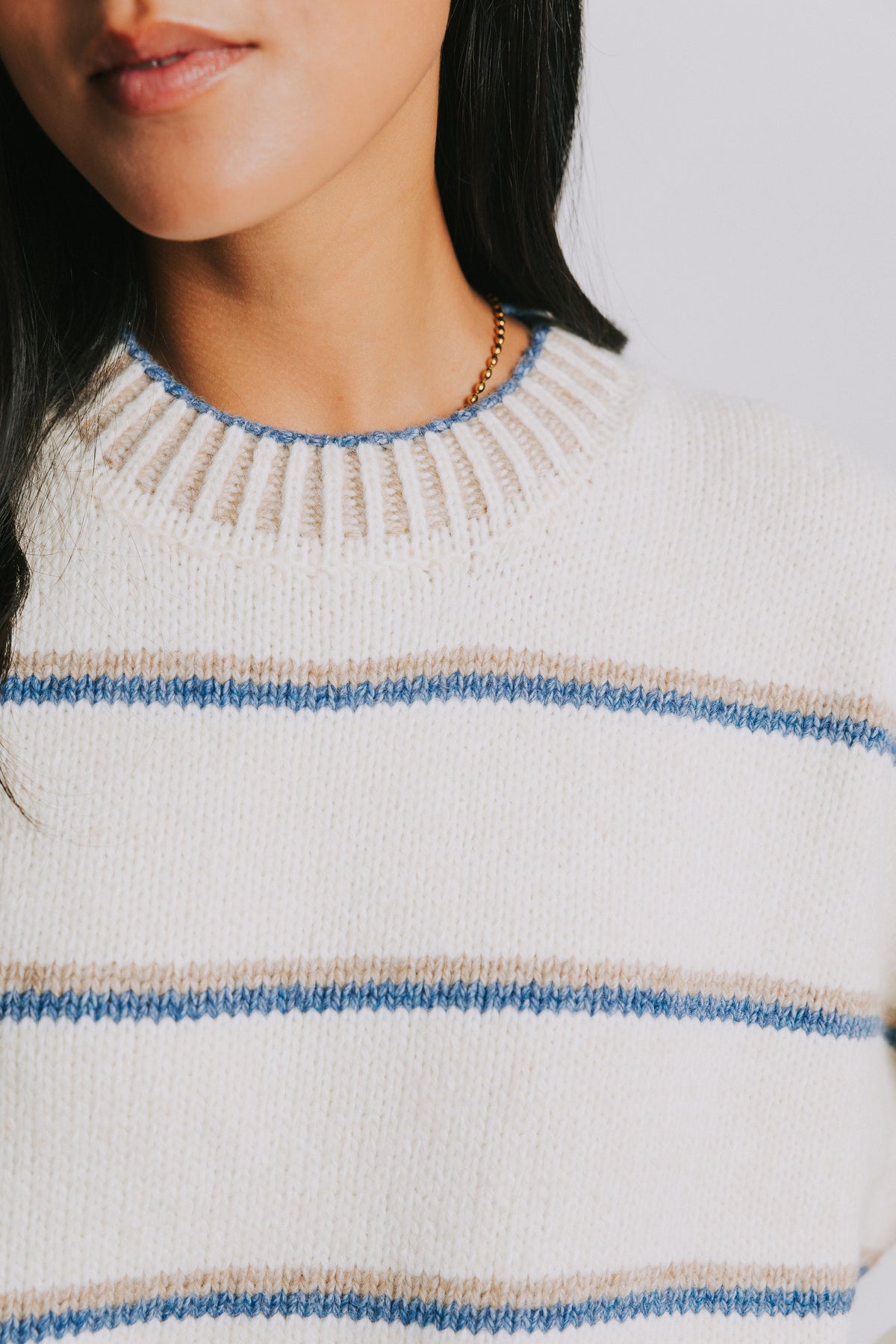 cream and blue striped crewneck sweater