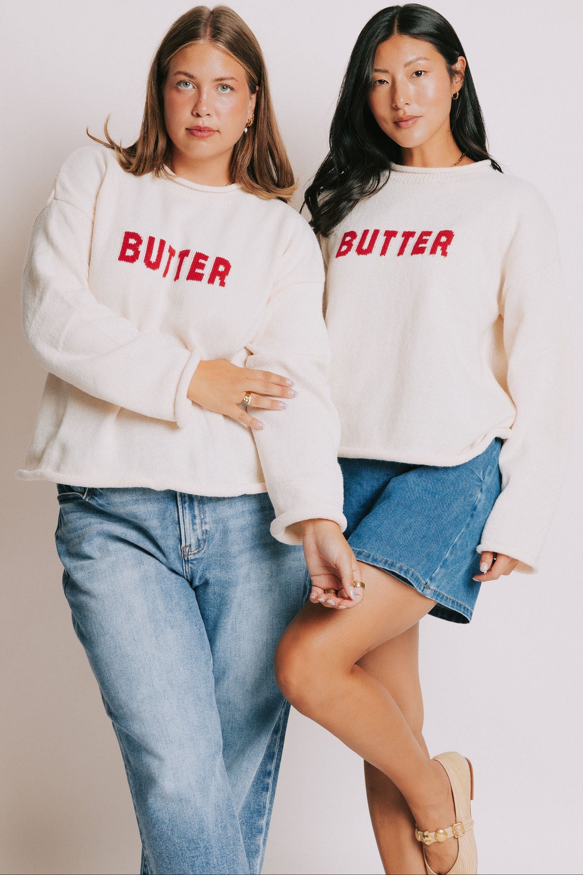 cream sweater with rolled edges and butter emblem models