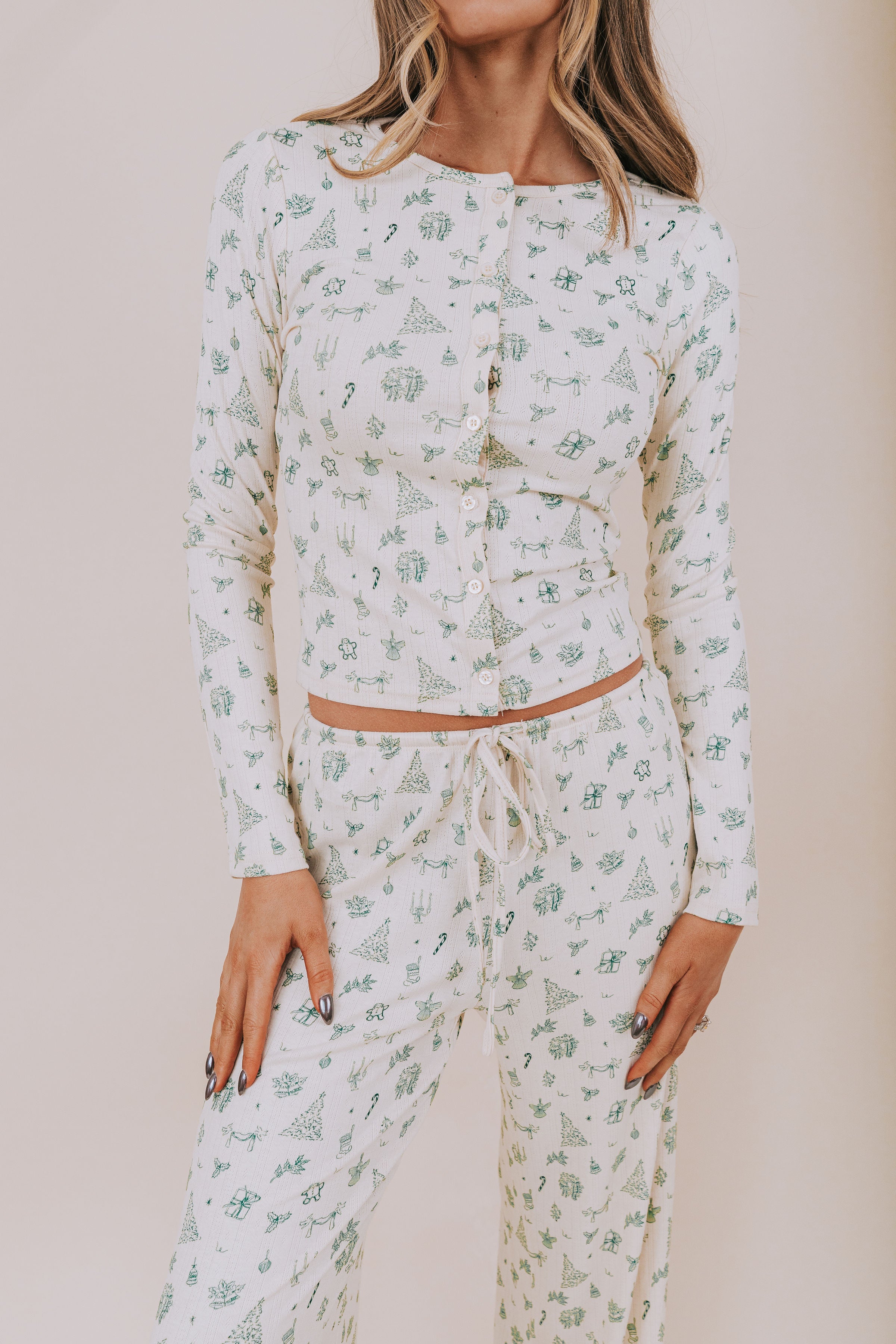 Christmas patterned pajama set worn by a person on a beige background
