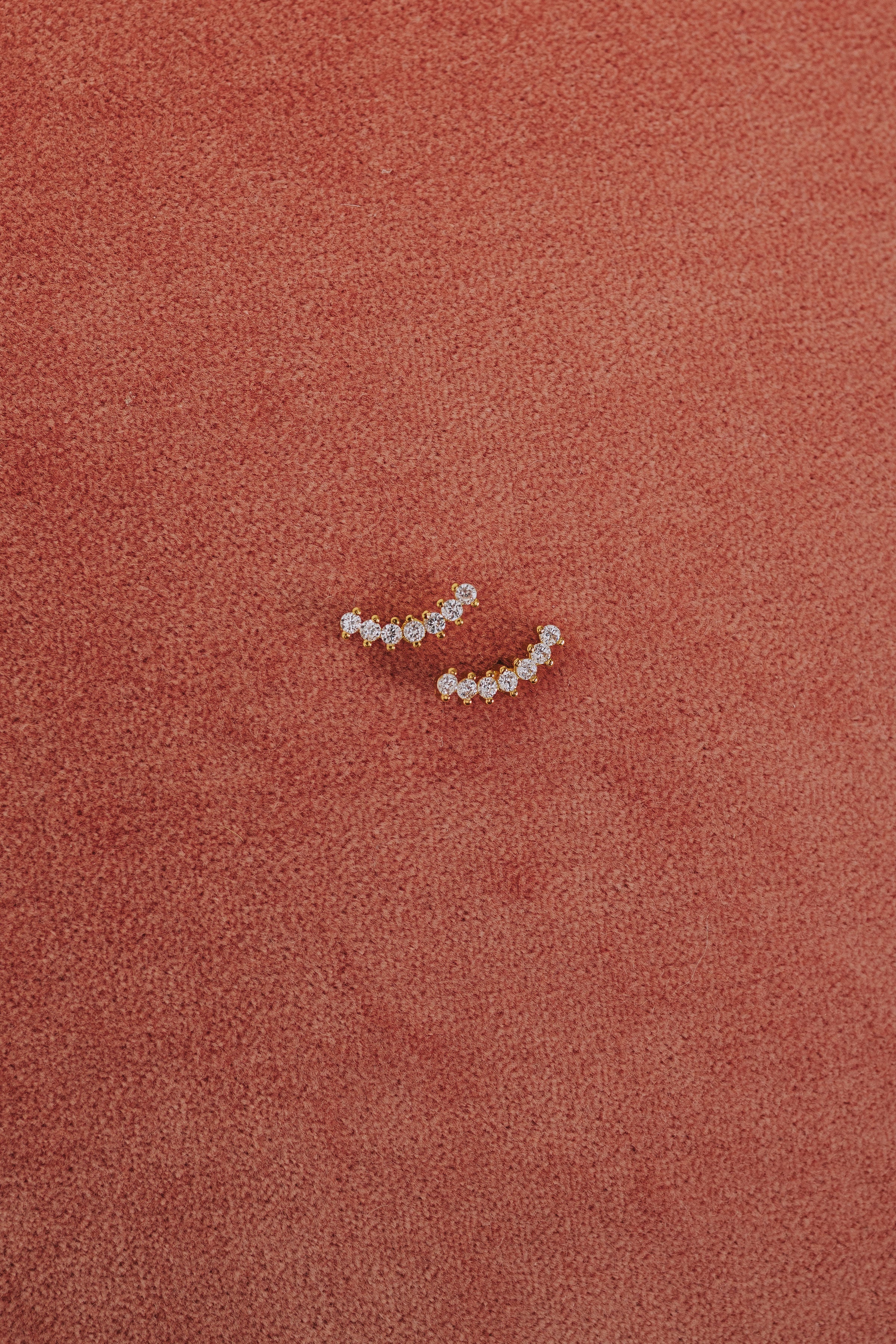 curved zirconia studded earring flatlay