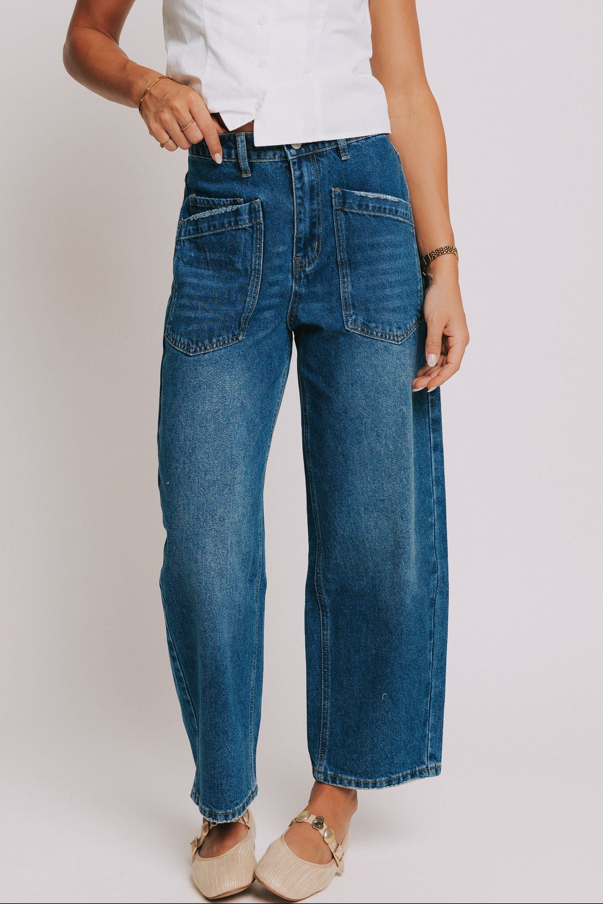 dark wash denim jeans with oversized front pockets 