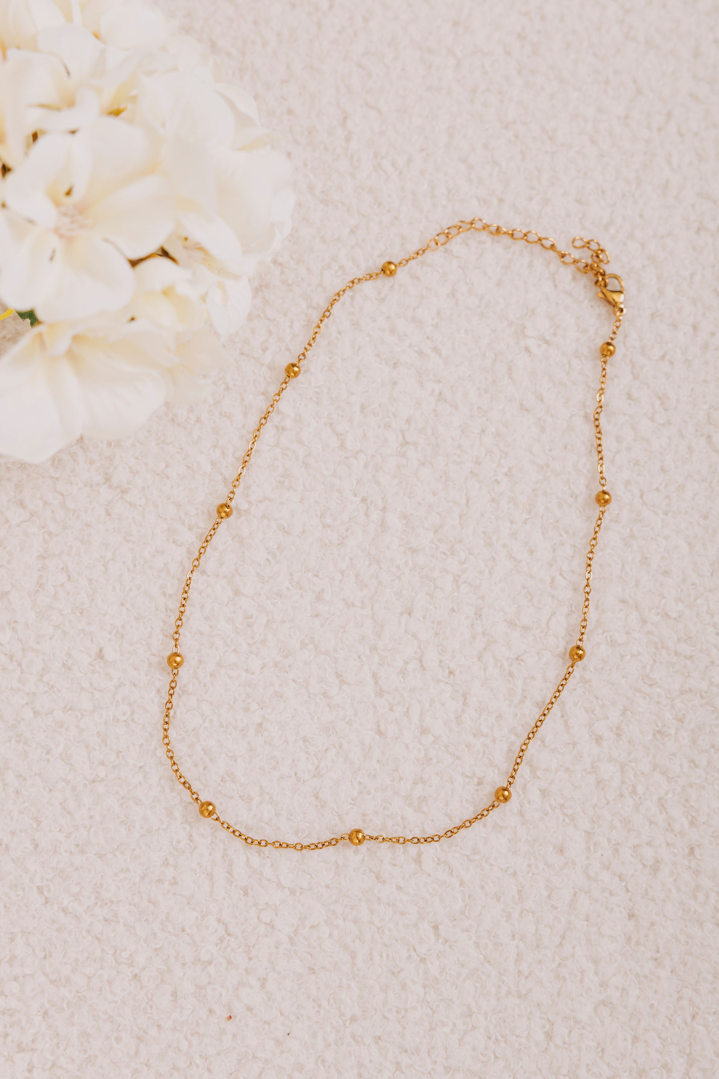gold ball bead chain necklace flatlay