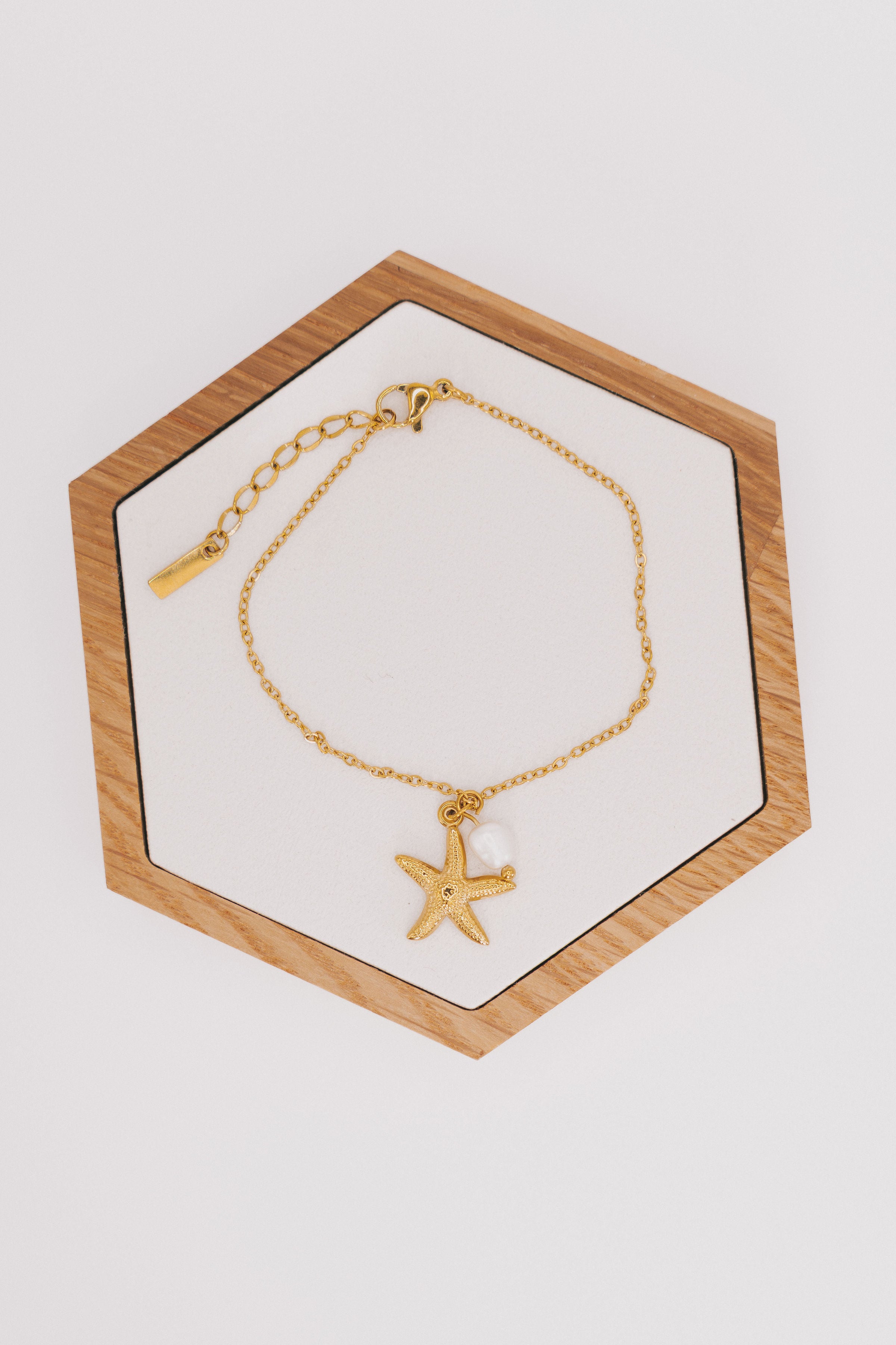 gold chain bracelet with starfish and pearl charm