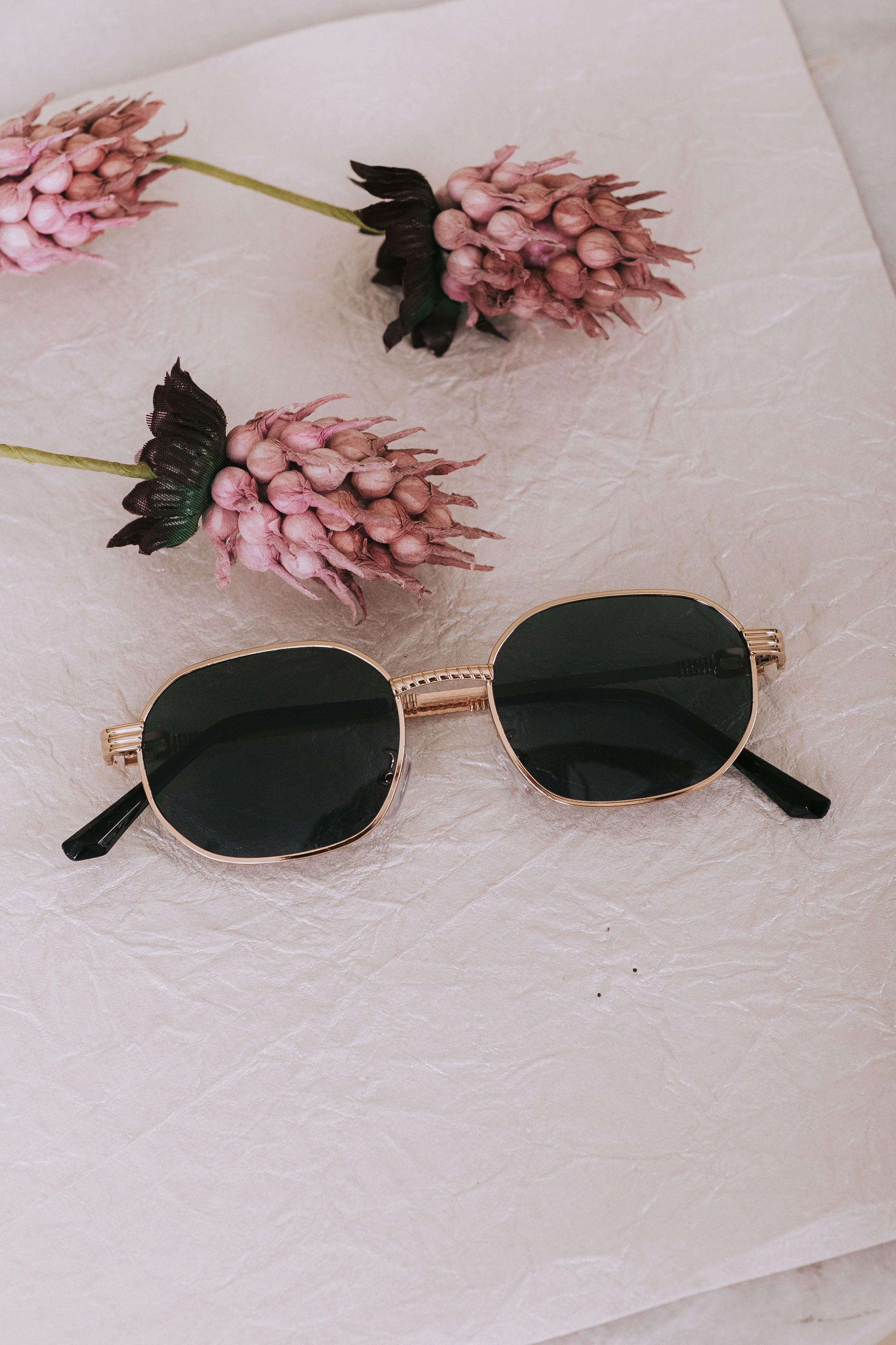textured sunglasses gold trim black lenses 