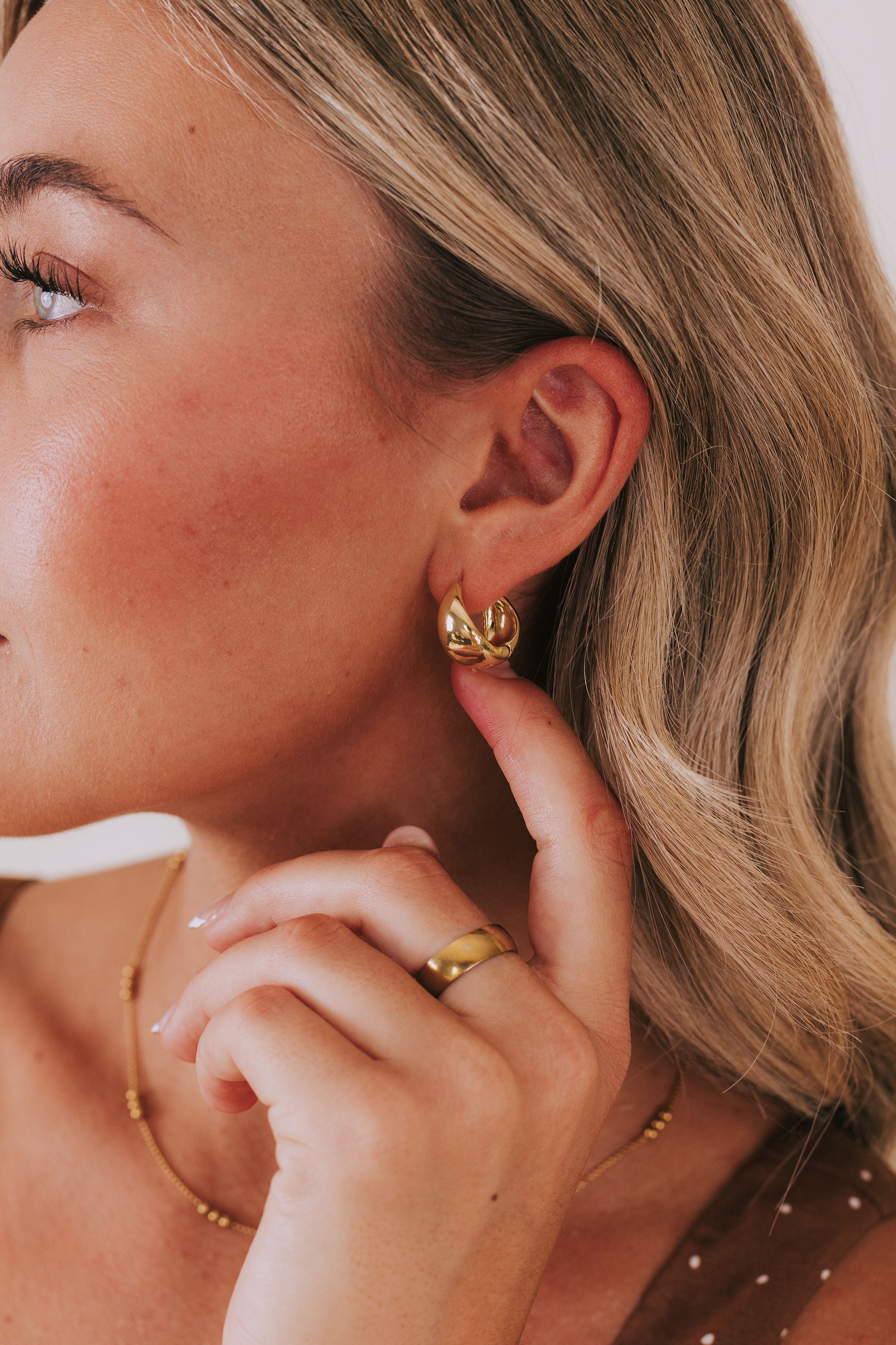 gold hoop earring with wide tapered shape