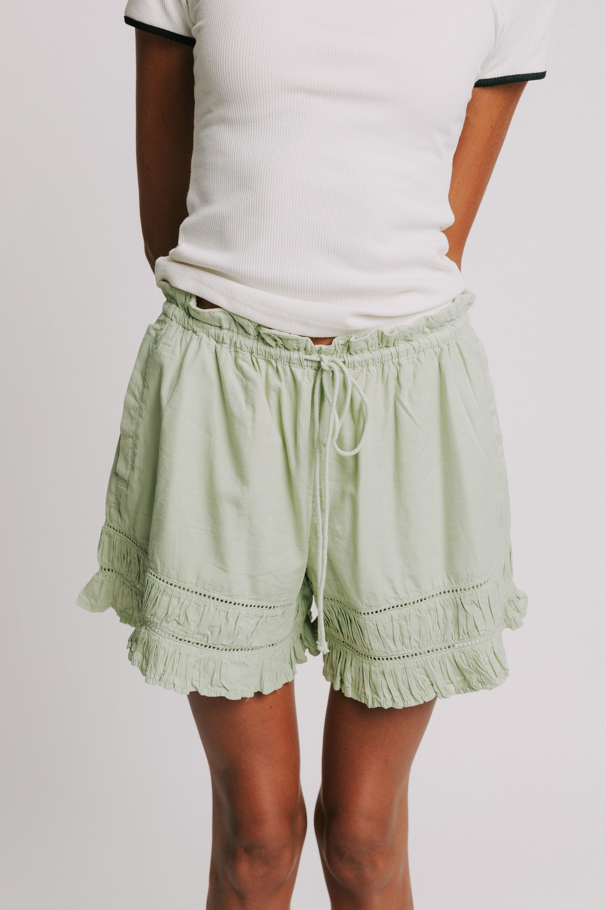green elastic waist shorts with ruffled trim 