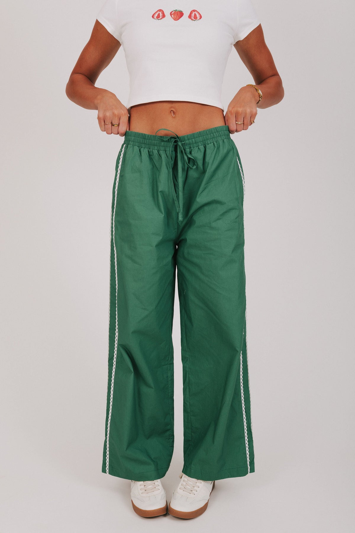 green track pants with lace edges 