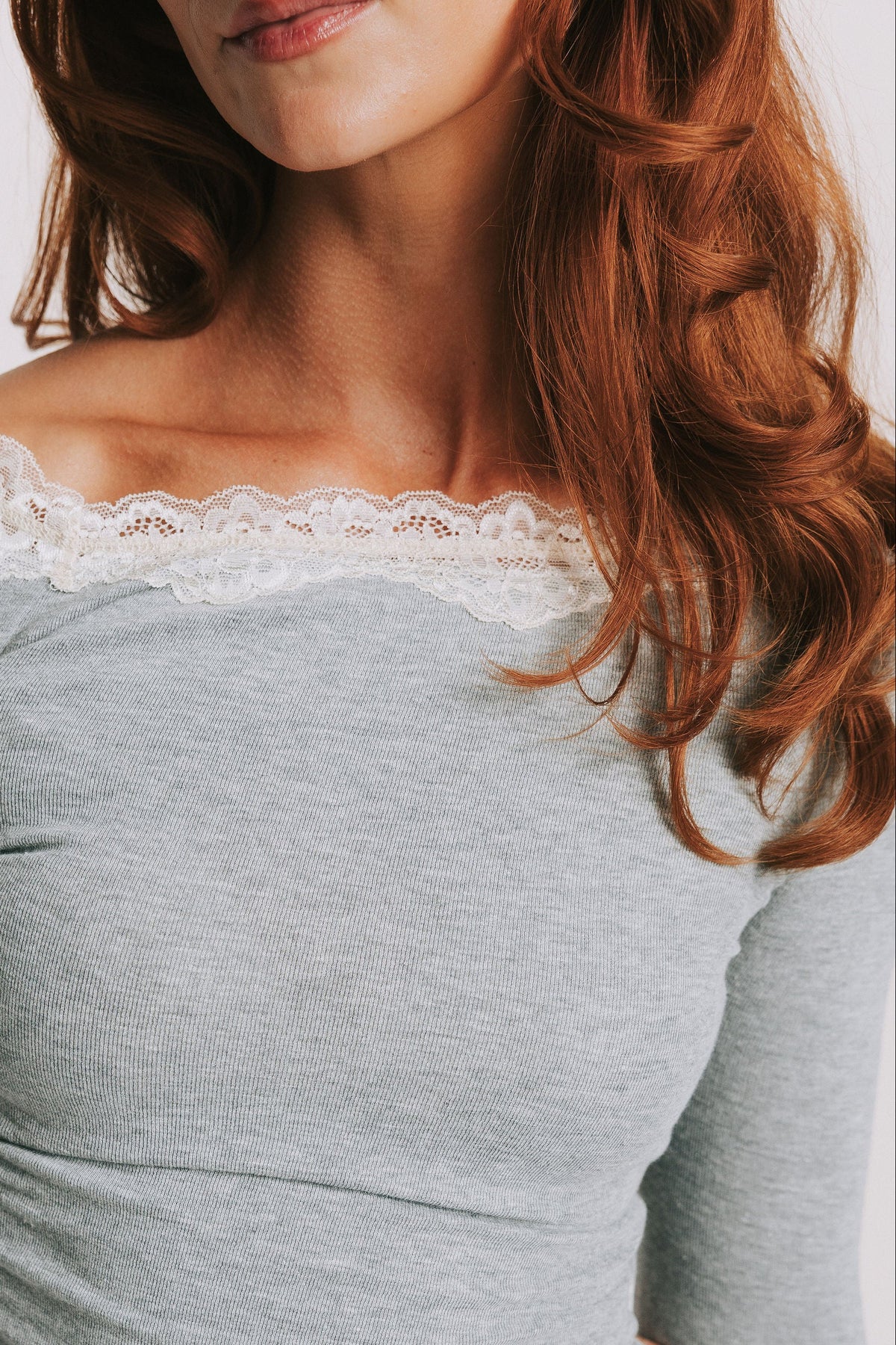 grey long sleeve top with lace trim on the neckline close