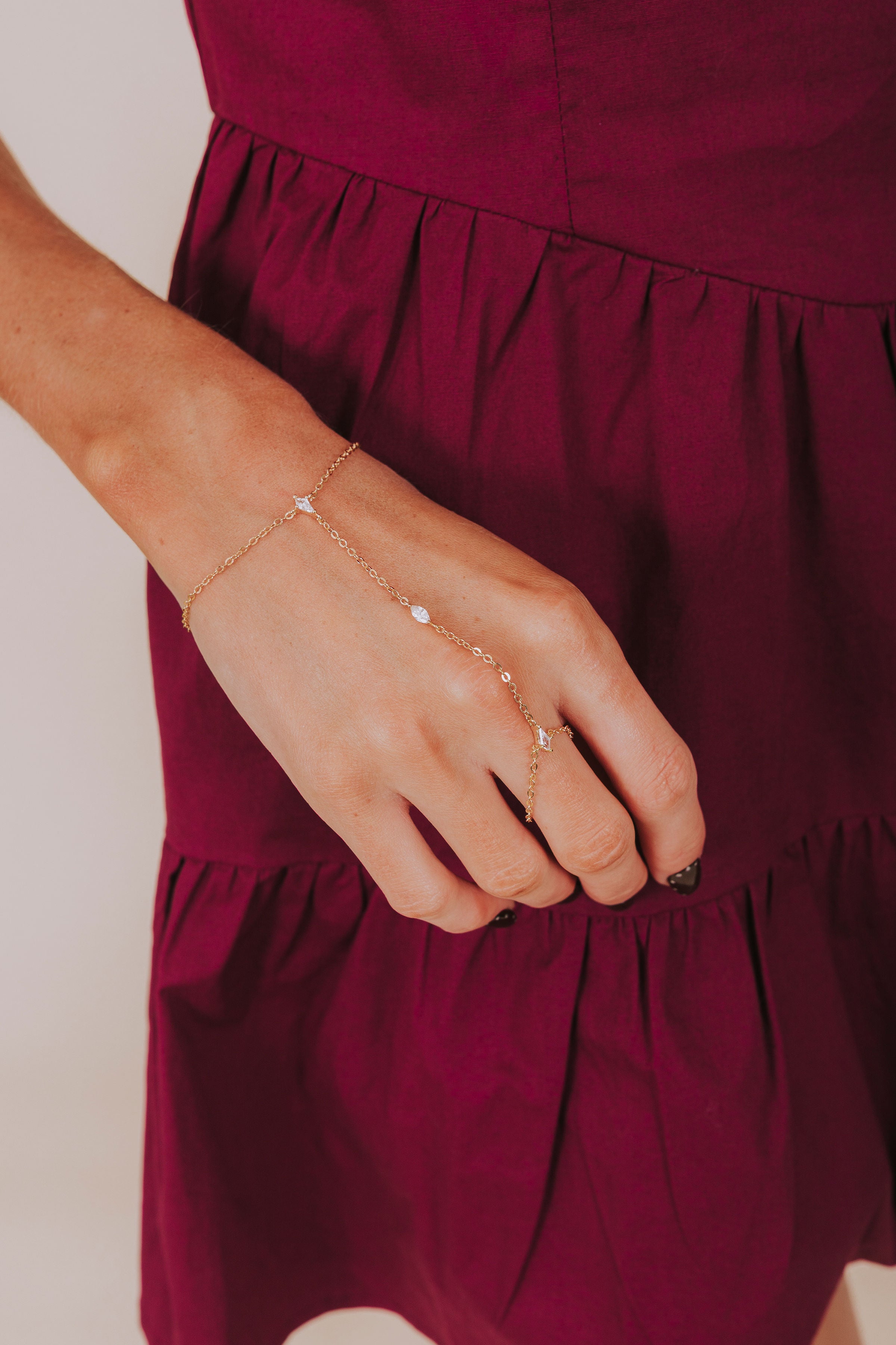 Close-up of a hand wearing a delicate bracelet 