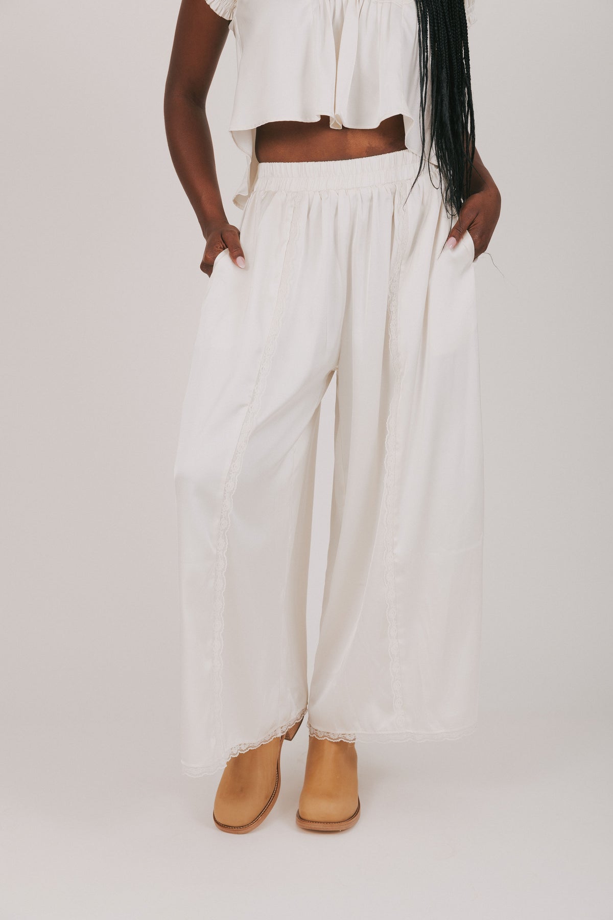 white satin pants with lace detailing 