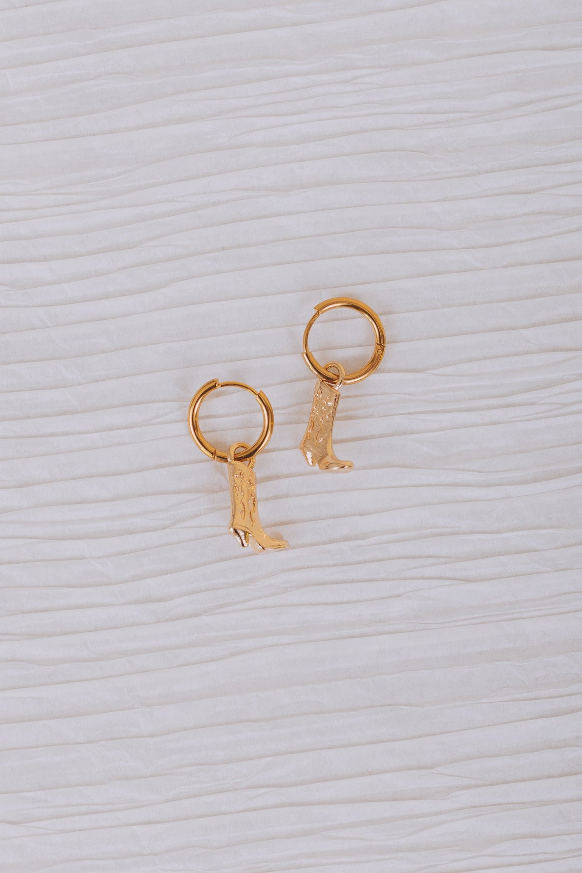gold hoop huggie earrings with cowboy boot dangle 