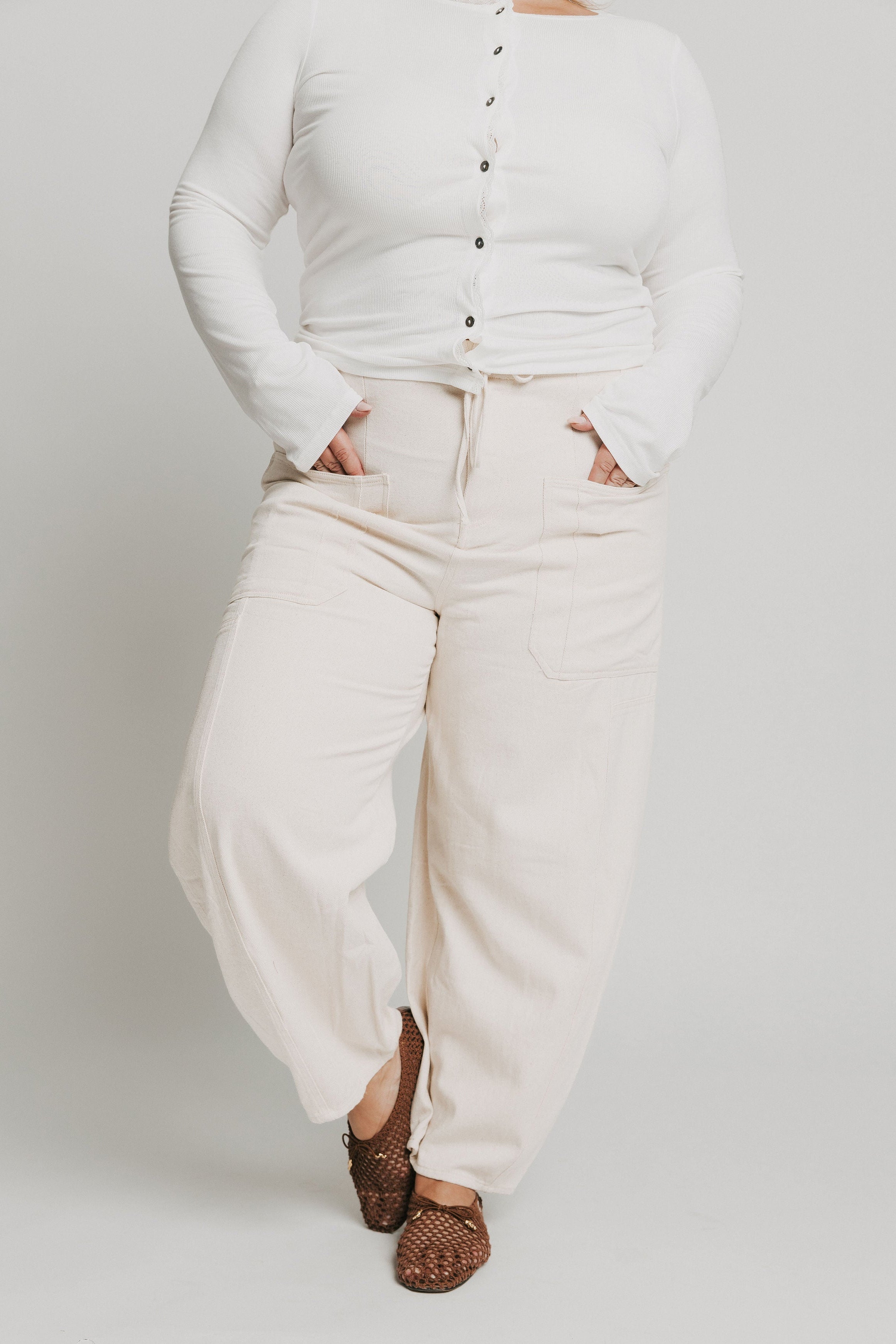 ivory barrel jeans with oversized pockets and tie at the waist