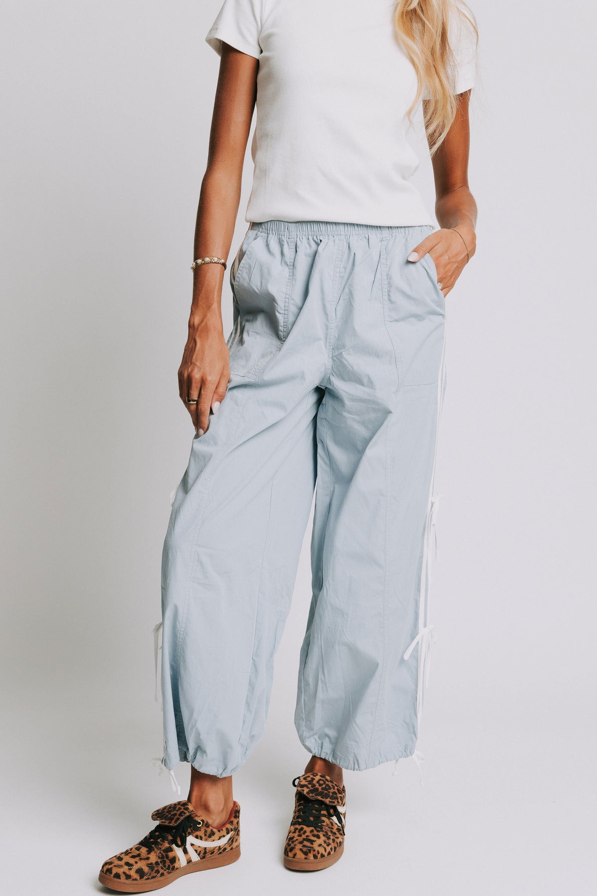 light blue track pants with elastic cuffs and side white stripes 