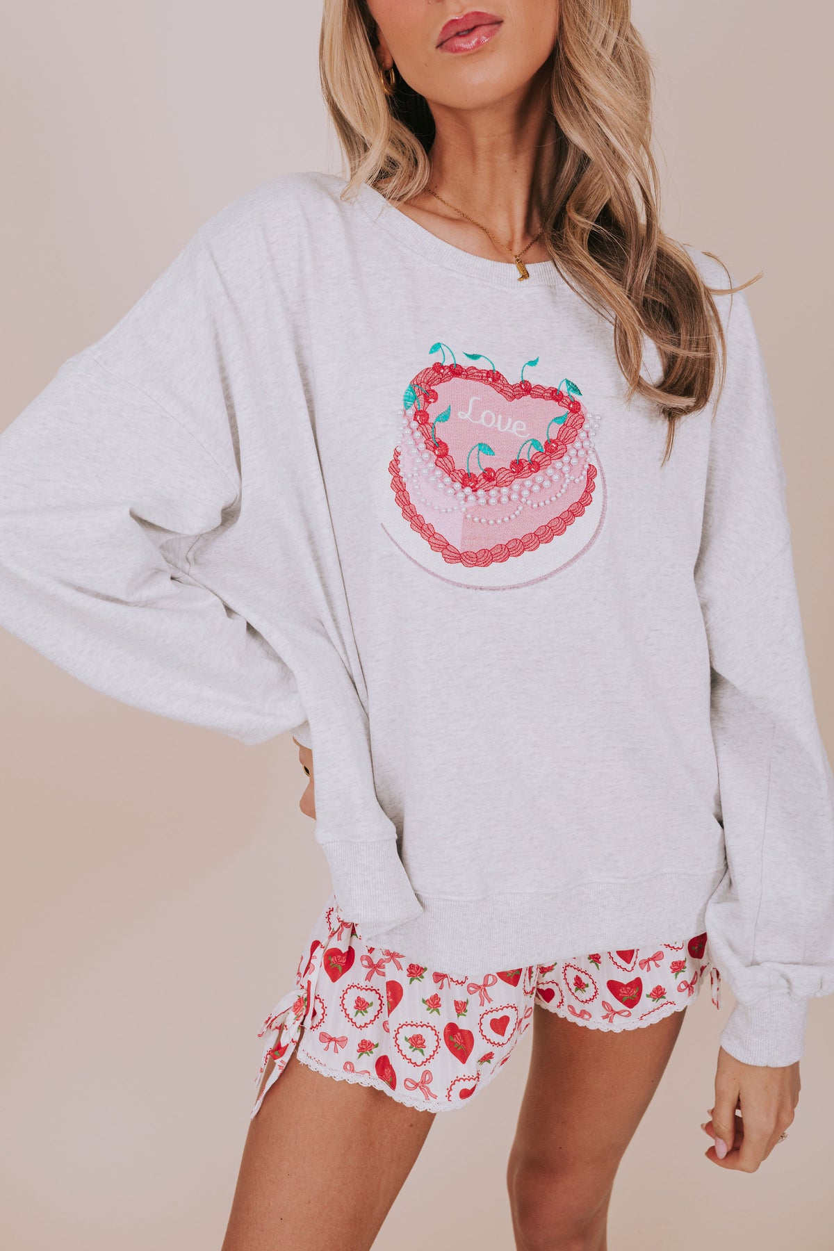 light grey sweatshirt with heart shaped cake close up