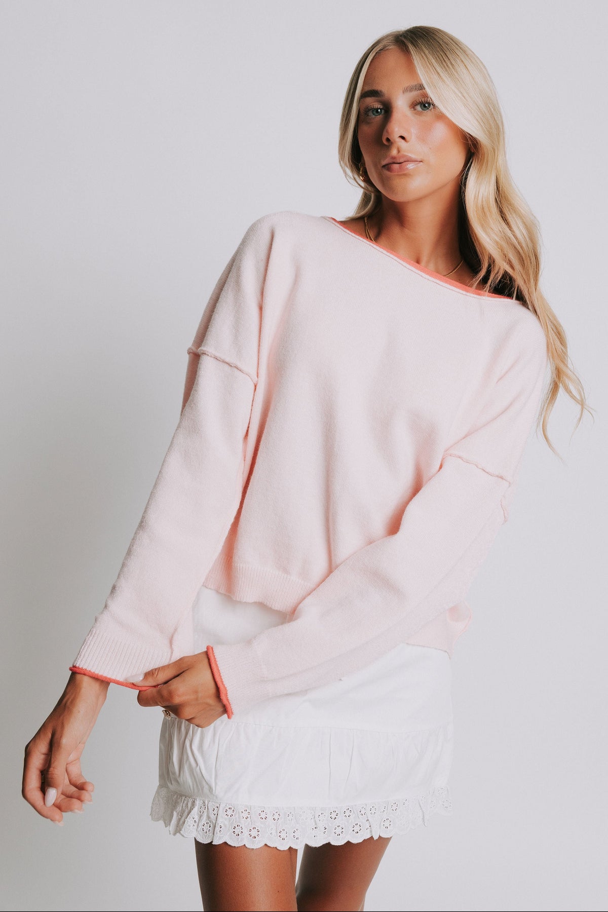 light pink sweater with raw seams and rolled edges 