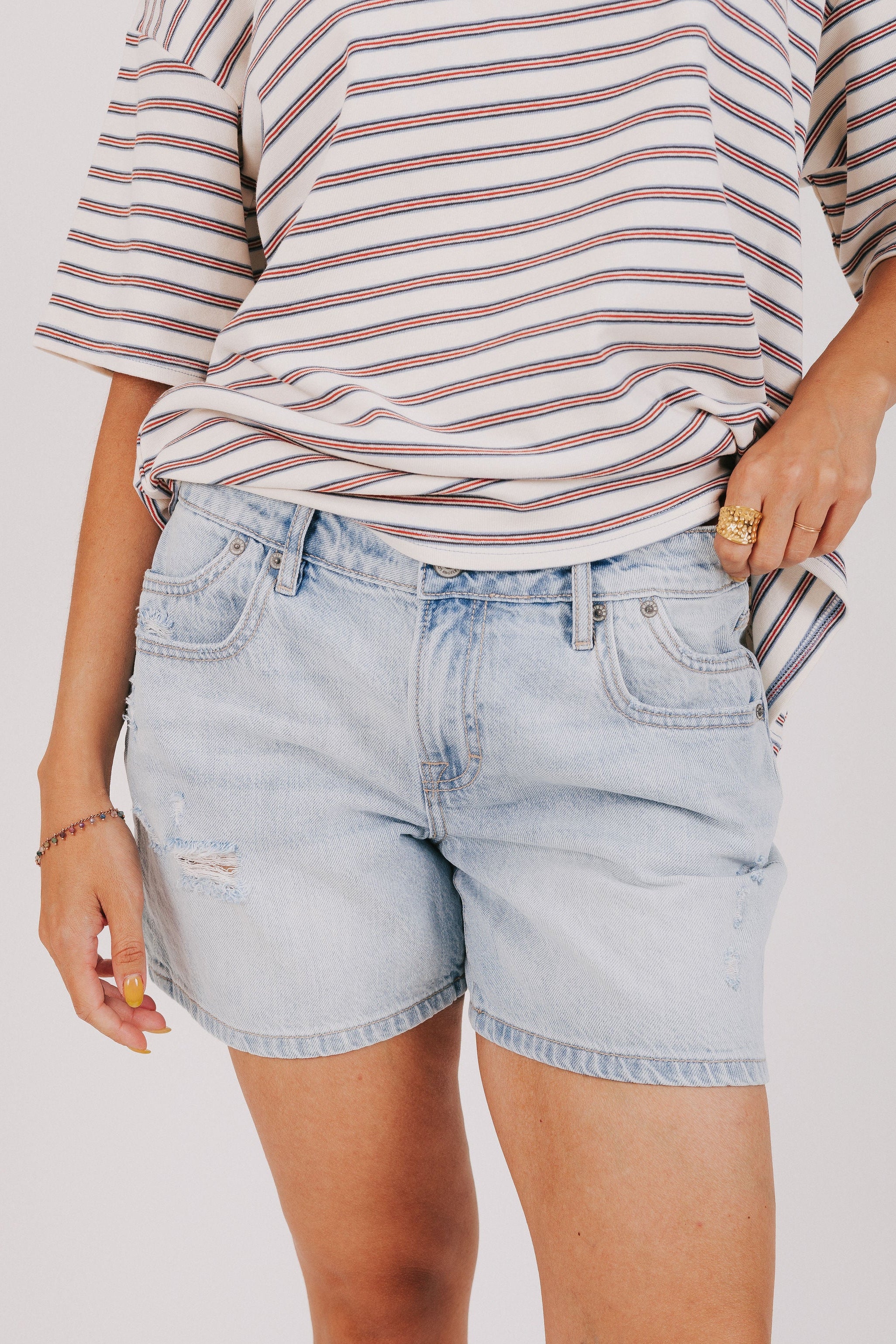light wash distressed denim shorts front