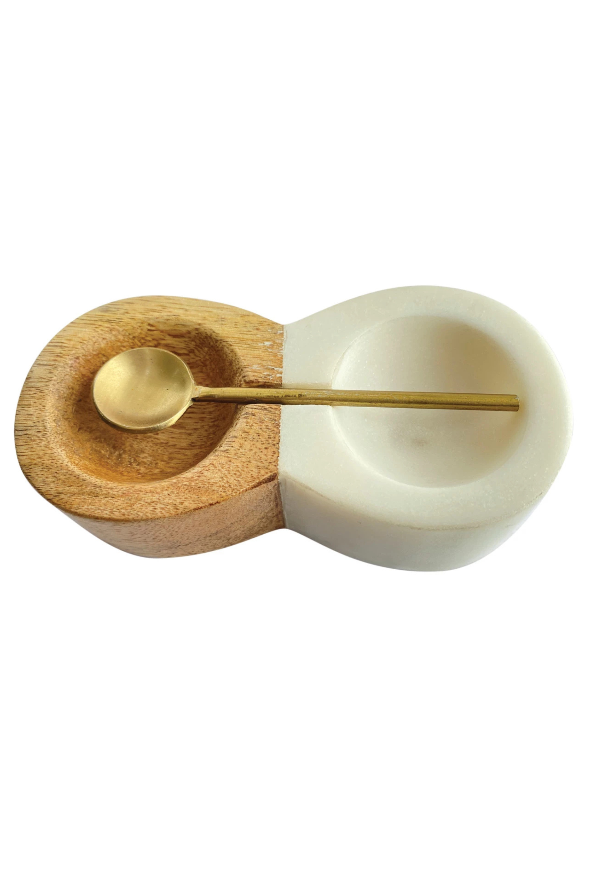 A pinch pot with two connected bowls, one made of mango wood, one made of marble, with a brass spoon.