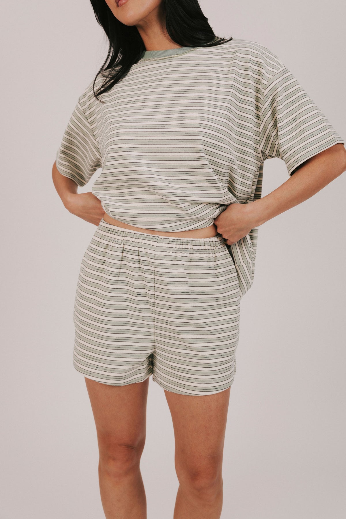 sage striped fleece shorts with pockets and an elastic waistband 