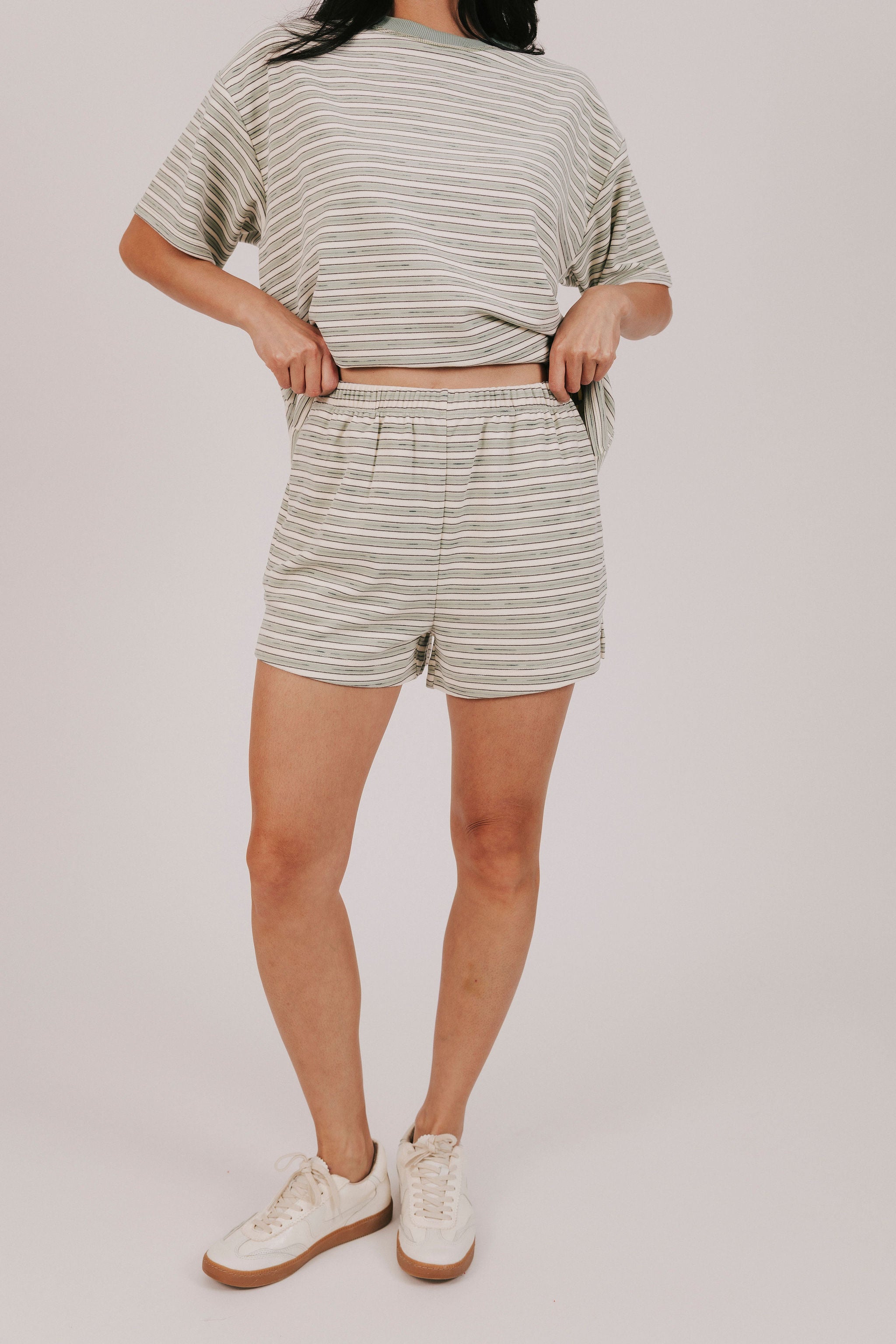 sage striped fleece shorts with pockets and an elastic waistband 